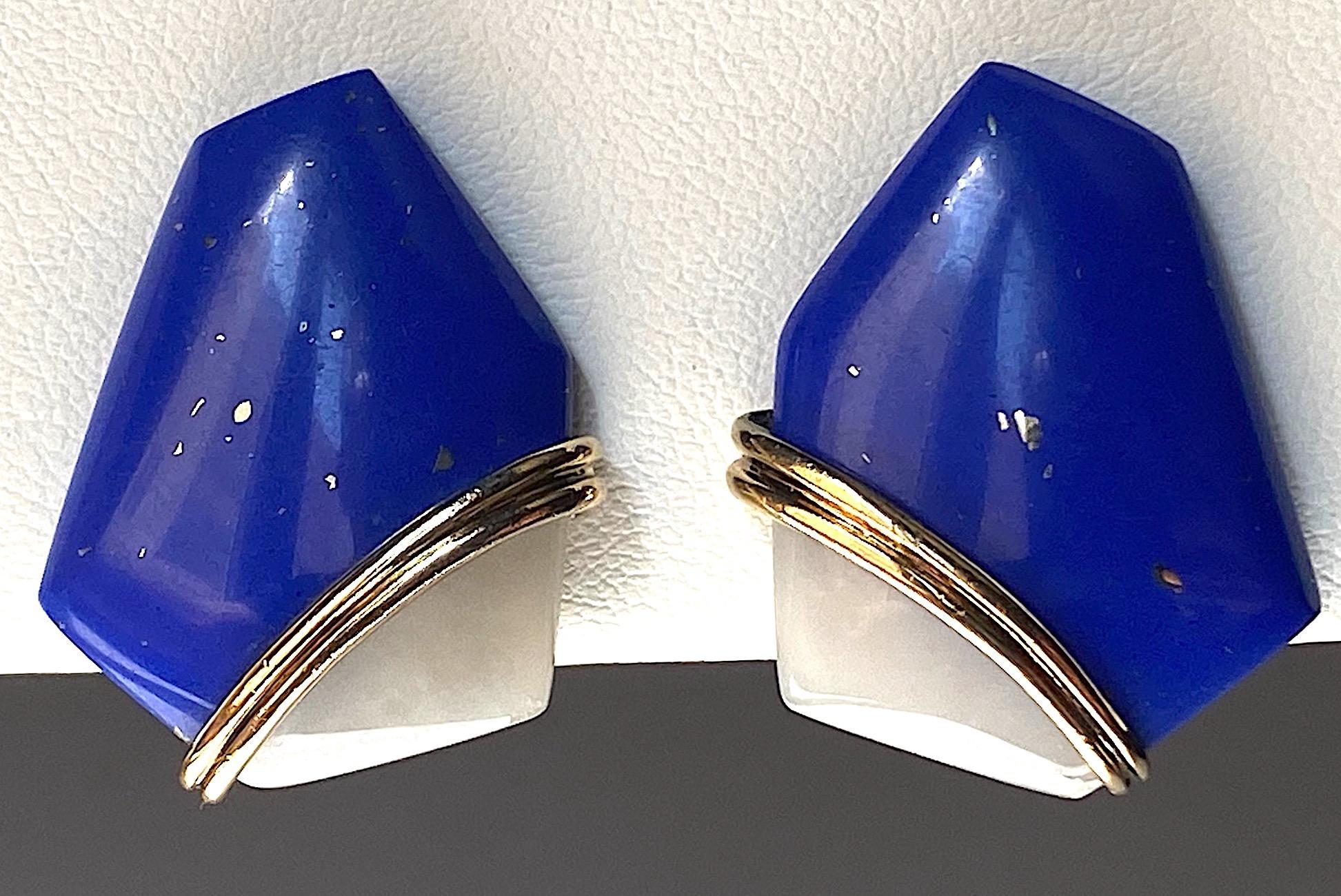 An elegant and modern design abstract pair of earrings by Kai-Yin Lo. Each is comprised of an asymmetric shape polished natural blue lapis lazuli stone accented by a wedge of opaque white quartz. The setting is gold on .925 sterling silver know as
