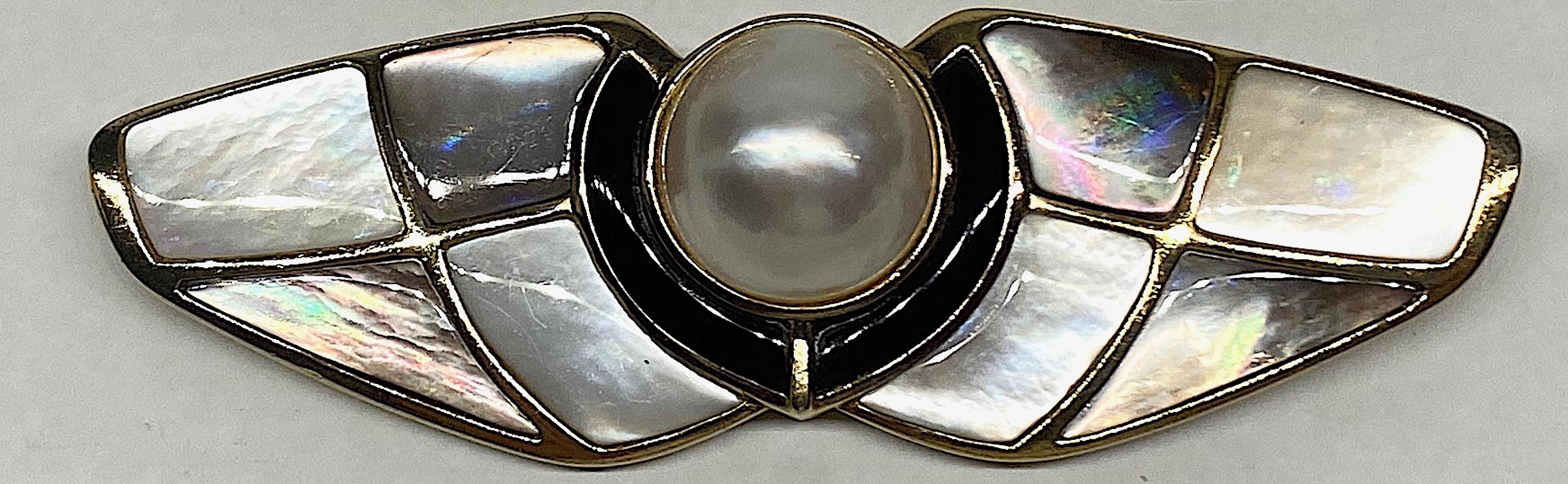 A beautifully and excellently crafted brooch by international jewelry designer Kai-Yin Lo. The brooch is comprised of a large 14 mm mabe pearl set into a vermeil (gold on sterling silver) setting. The pearl is surrounded along the sides and bottom