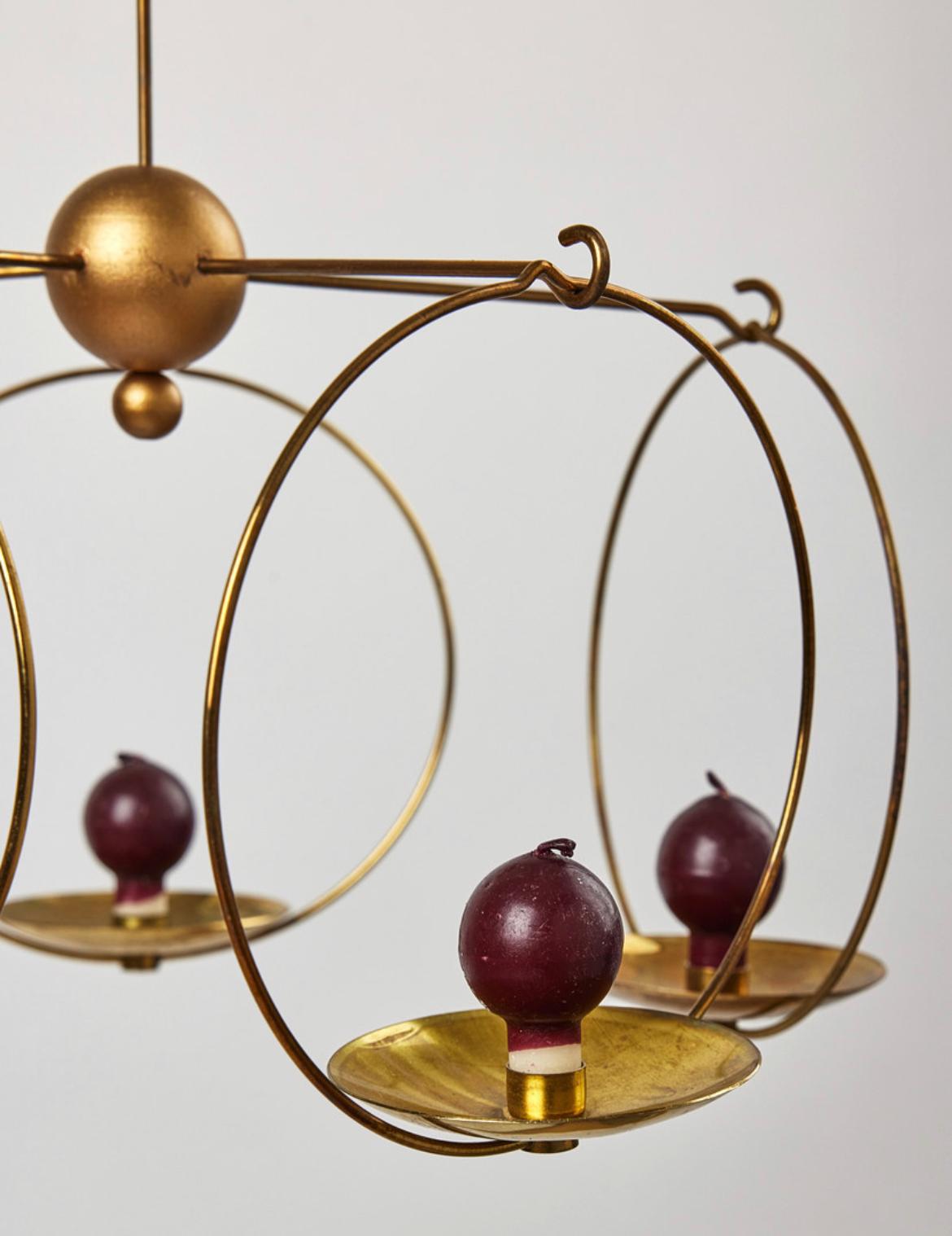 Rare and uncommon pair of Kaija Aarikk & Timo Sarpaneva brass chandeliers for candles made in Finland in the 1950’s.

This pair of chandeliers will add a warm charming touch to your home.
The chandeliers are the perfect detail for any style of