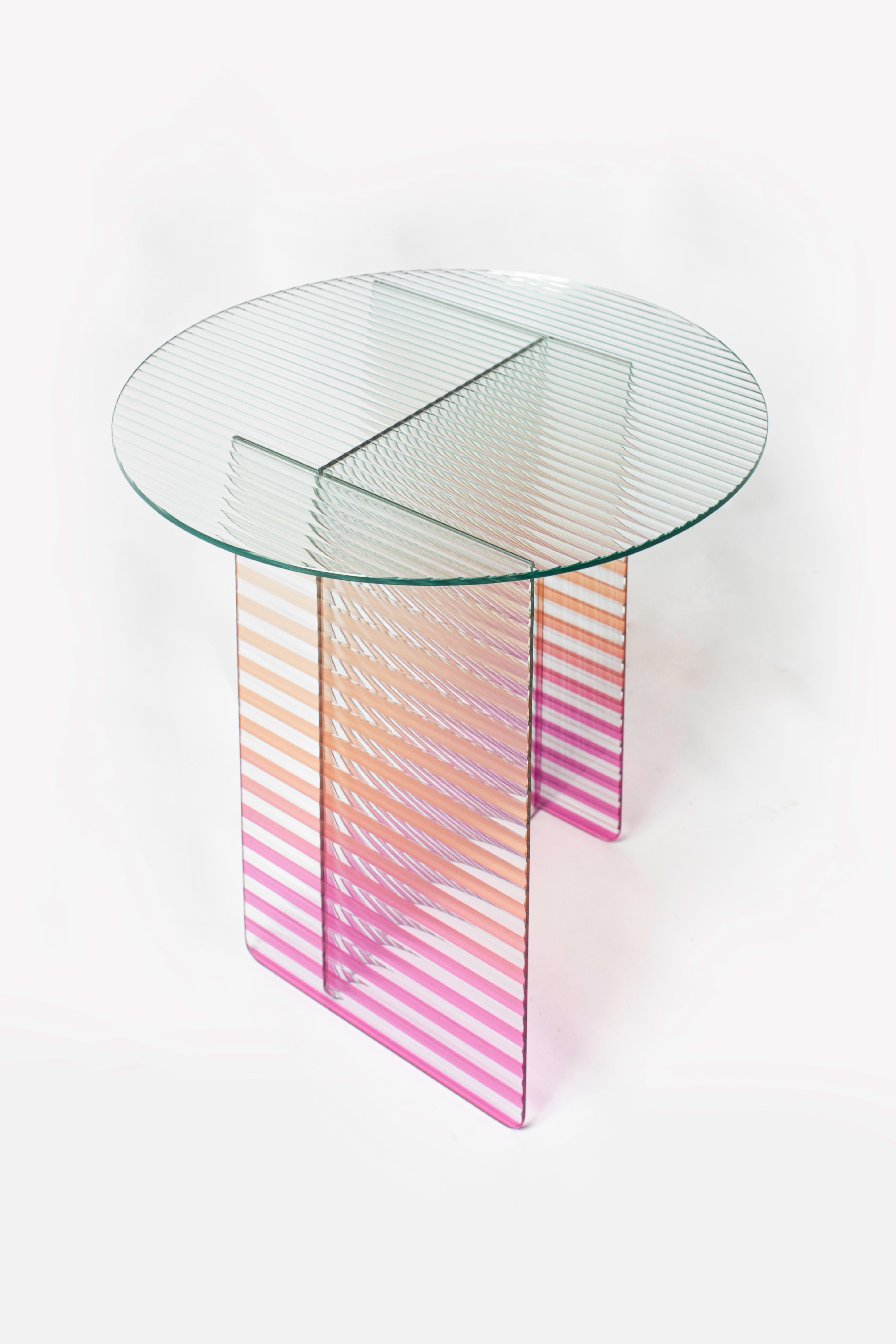 Kaila Medium Side Table by Yugen Lab
Dimensions: Ø 51 x H 42 cm.
Materials: 6mm tempered ribbed glass.

Kaila Medium side table boasts an elegant ribbed glass design with carefully chosen gradient colors, adding a maximalist touch. Legs, colored
