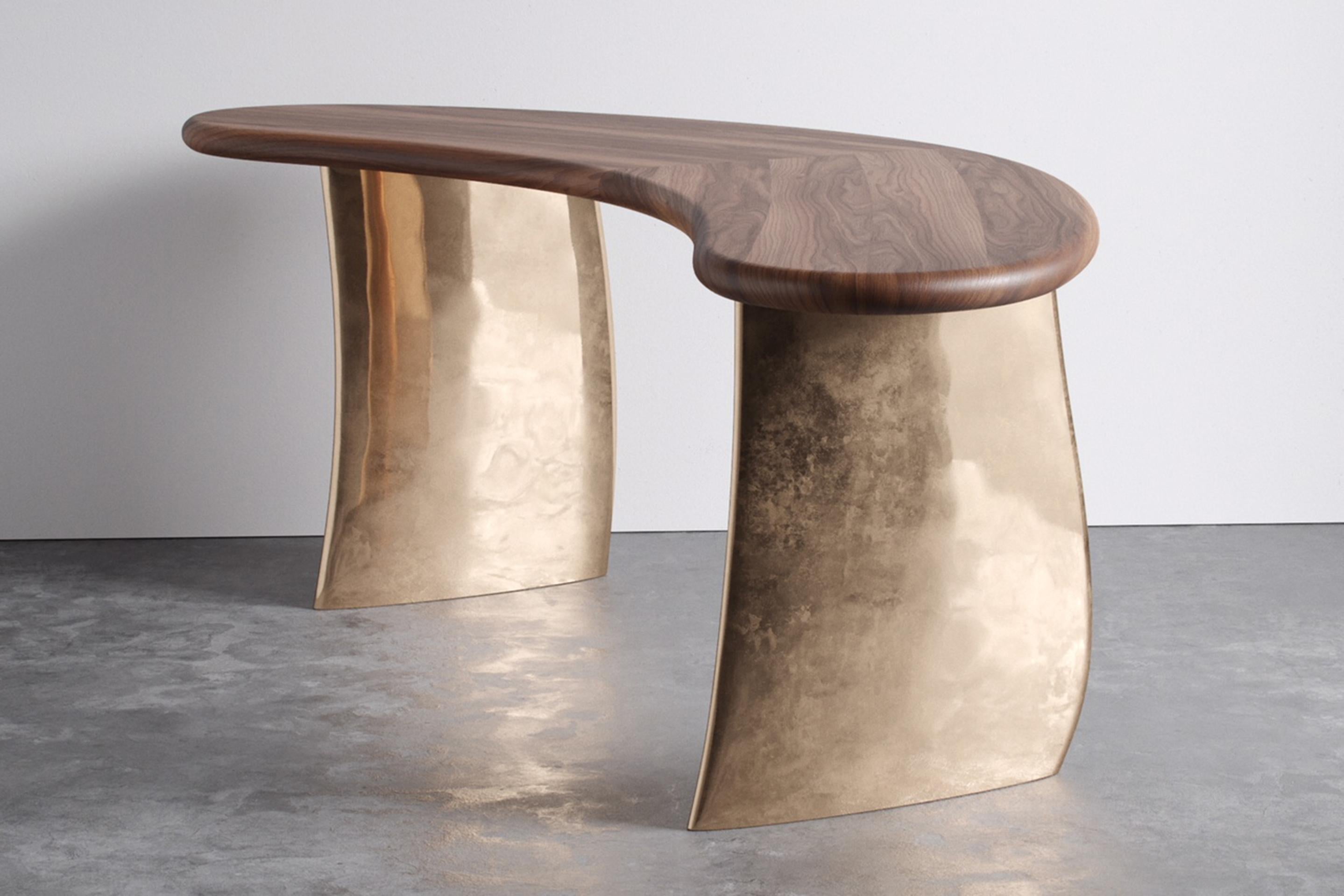 Kaimana desk by Aguirre Design
Dimensions: L 213.4 x W 66 x H 76.2 cm
Materials: Clear solid walnut, polished cast bronze legs

A modern desk with natural characteristics. Solid walnut and cast bronze pedestals. It begins with two thick, cast