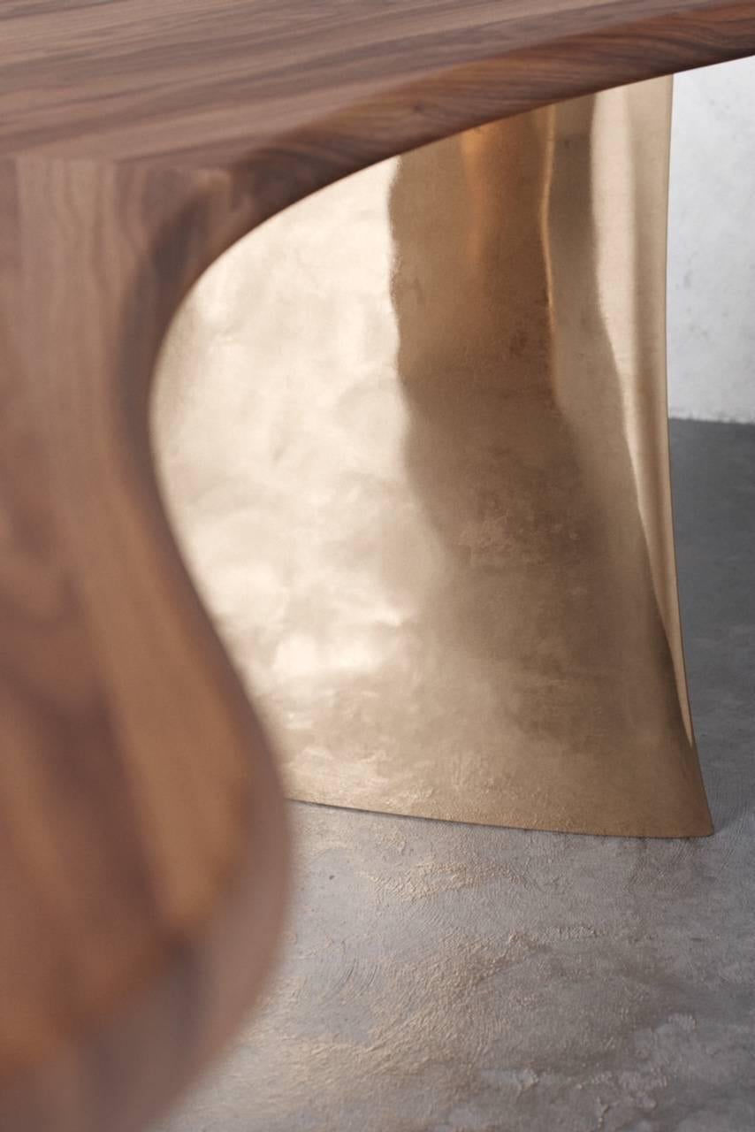 Bold and sculptural, the Kaimana Desk takes its inspiration from the elements. It begins with two thick, cast bronze pedestals, formed through the magic of fire. Thickest at their base, the legs are lightly treated with antique patina and polished