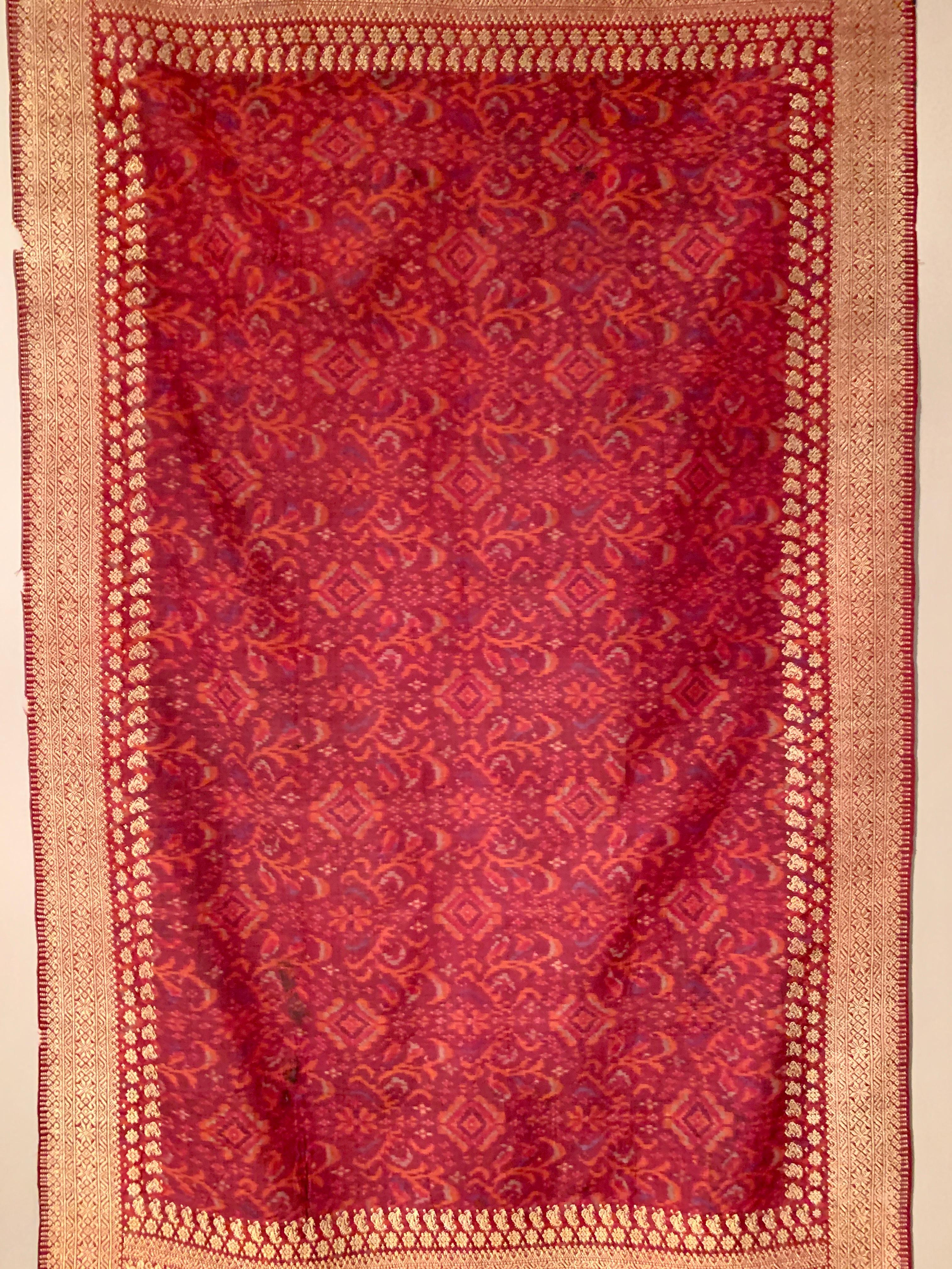 A rich and luxurious kain limar songket, shoulder cloth for a woman, ikat dyed and woven silk (limar) with supplementary weft woven metallic gold thread brocade (songket), circa 1900 or earlier, Palembang, Sumatra, Indonesia. 

This stunning