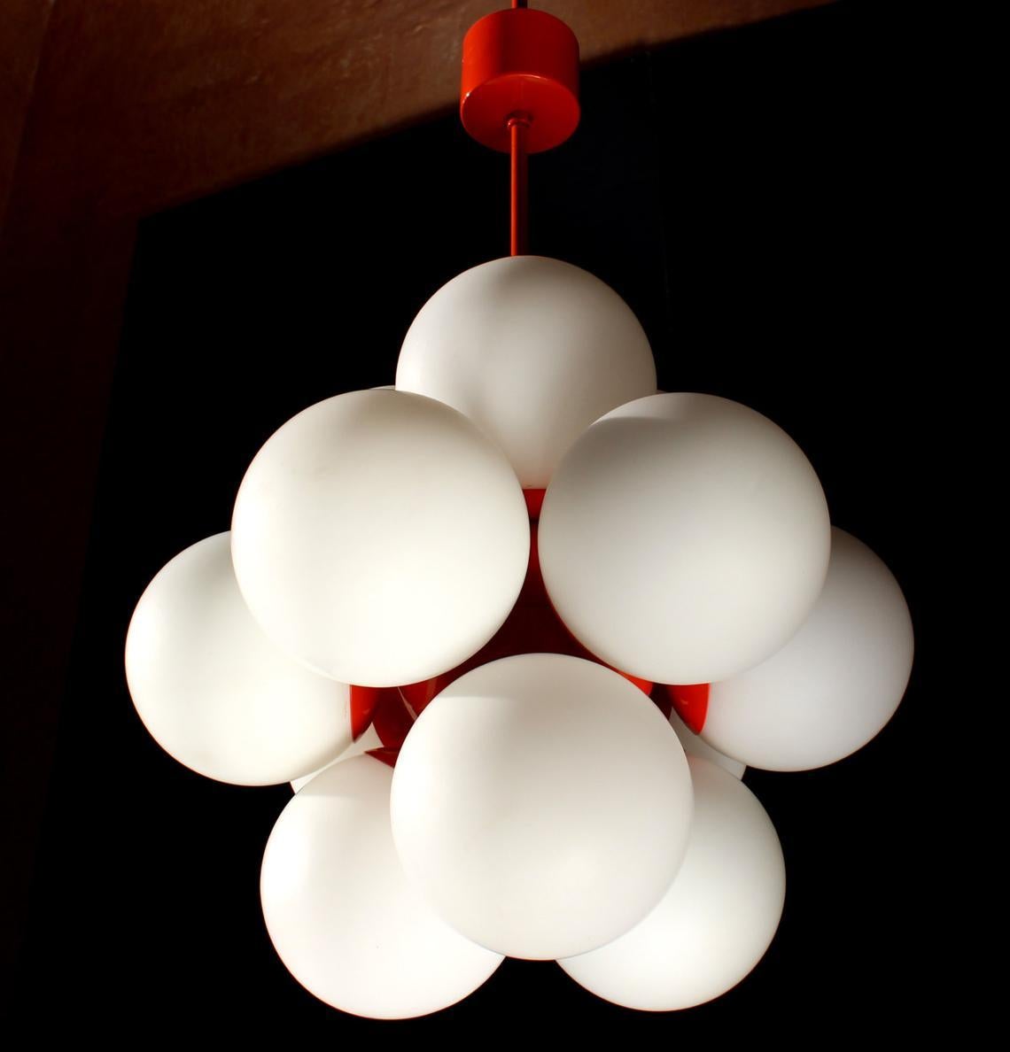 Chandelier with 12 lights ( E14) in red/orange enameled surface with opal glass. Diameter 19,5