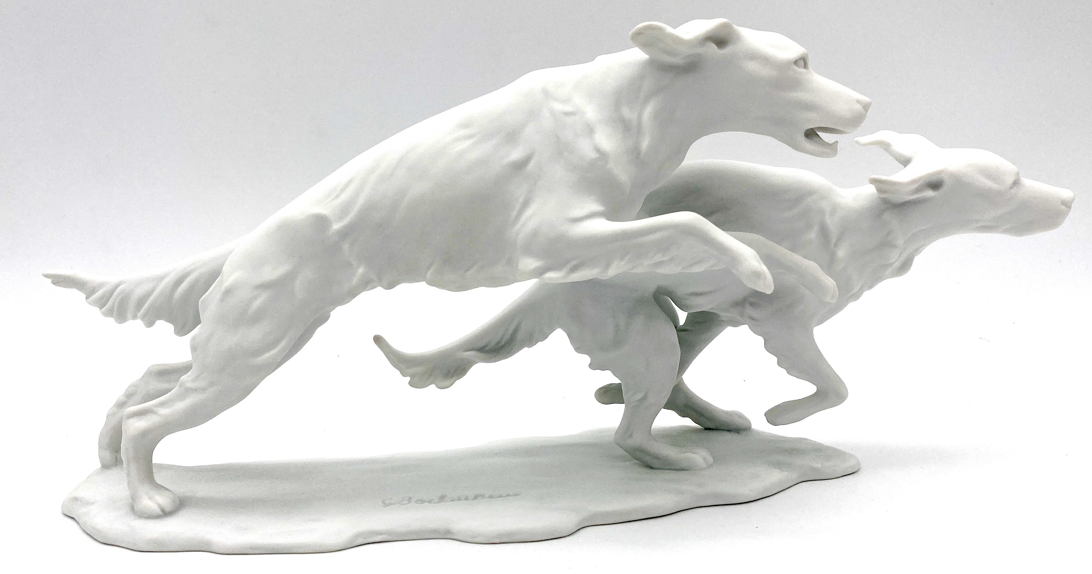 Kaiser Bisque Porcelain 'Running Dogs' by G. Bochuraun (b. 1925) 
Impressed signature of G. Bochuraun on the base

 A Magnificent Kaiser Bisque Porcelain sculpture titled 'Running Dogs' by G. Bochuraun (b. 1925). The finely modeled grouping features