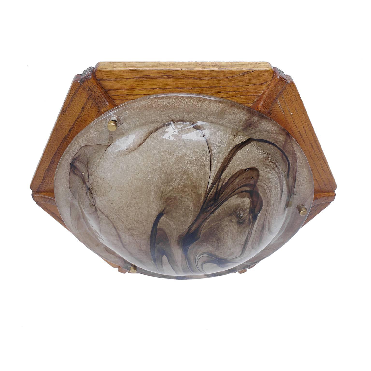 Elegant flush mount ceiling light executed in Murano glass with brass finals on a wooden frame. Manufactured by Kaiser Lighting, Germany in the 1960s.

Materials: Murano glass, brass and wood.
Colors: amber, golden and brown.
Measures: height 5.52