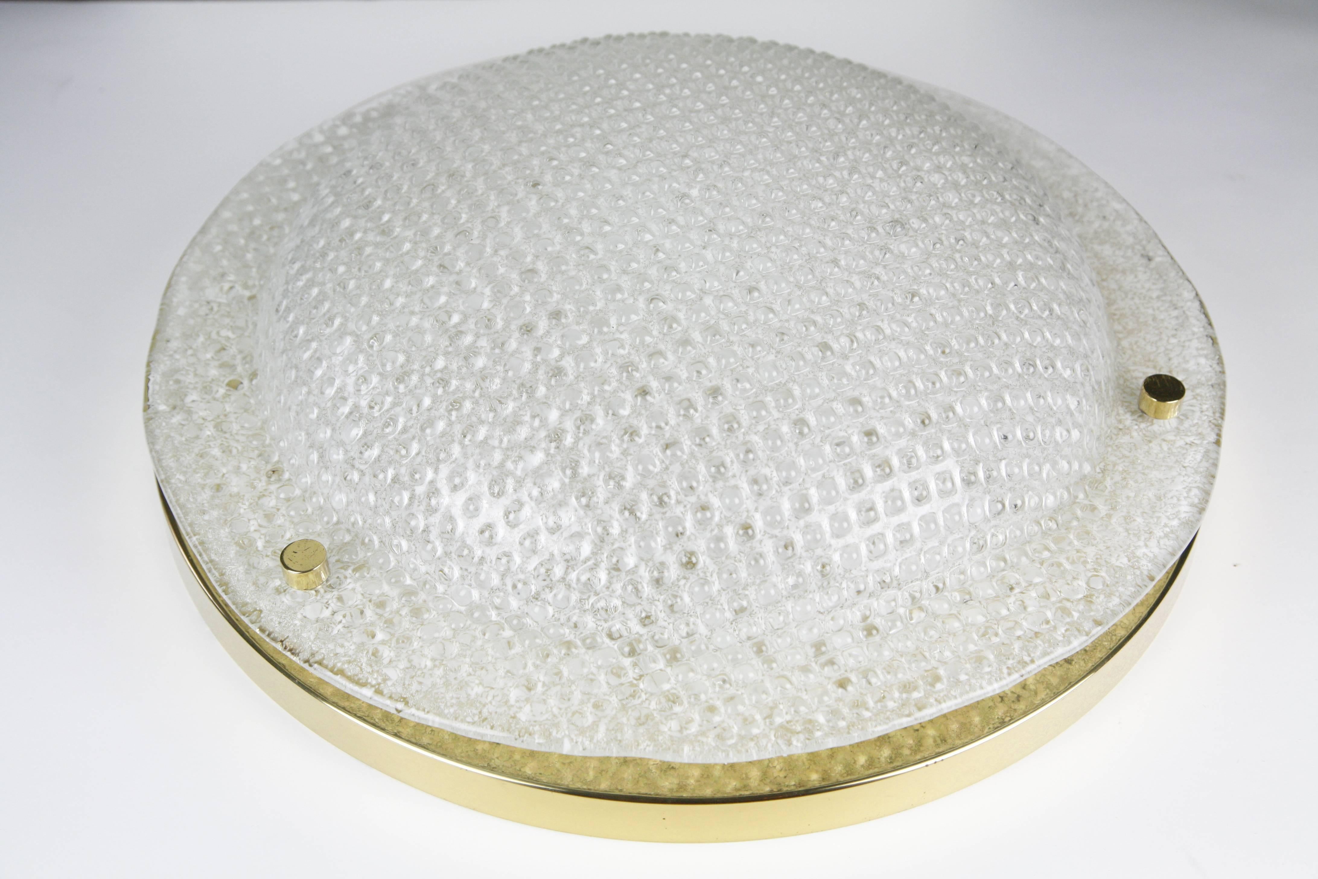 Domed shaped Kaiser glass flushmount, 1970 with waffle texture on a brass mount in great condition with original four Edison ceramic sockets.


