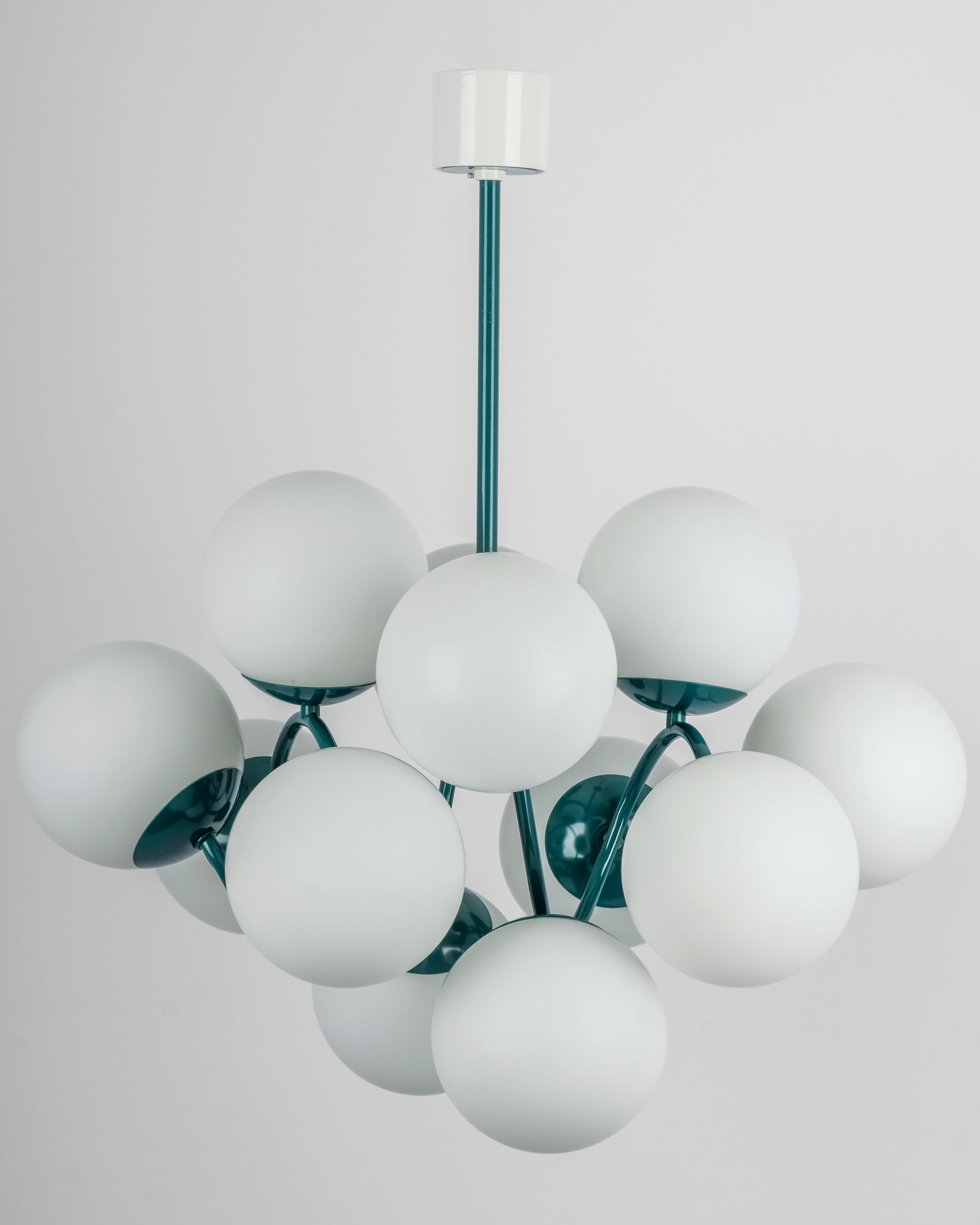 Wonderful Sputnik chandelier made by Kaiser Leuchten, Germany, circa 1970-1979.
Great Atomium-shaped chandelier with 12 opal glasses.

High quality and in very good condition. Cleaned, well-wired and ready to use. 

The fixture requires 12 x E27