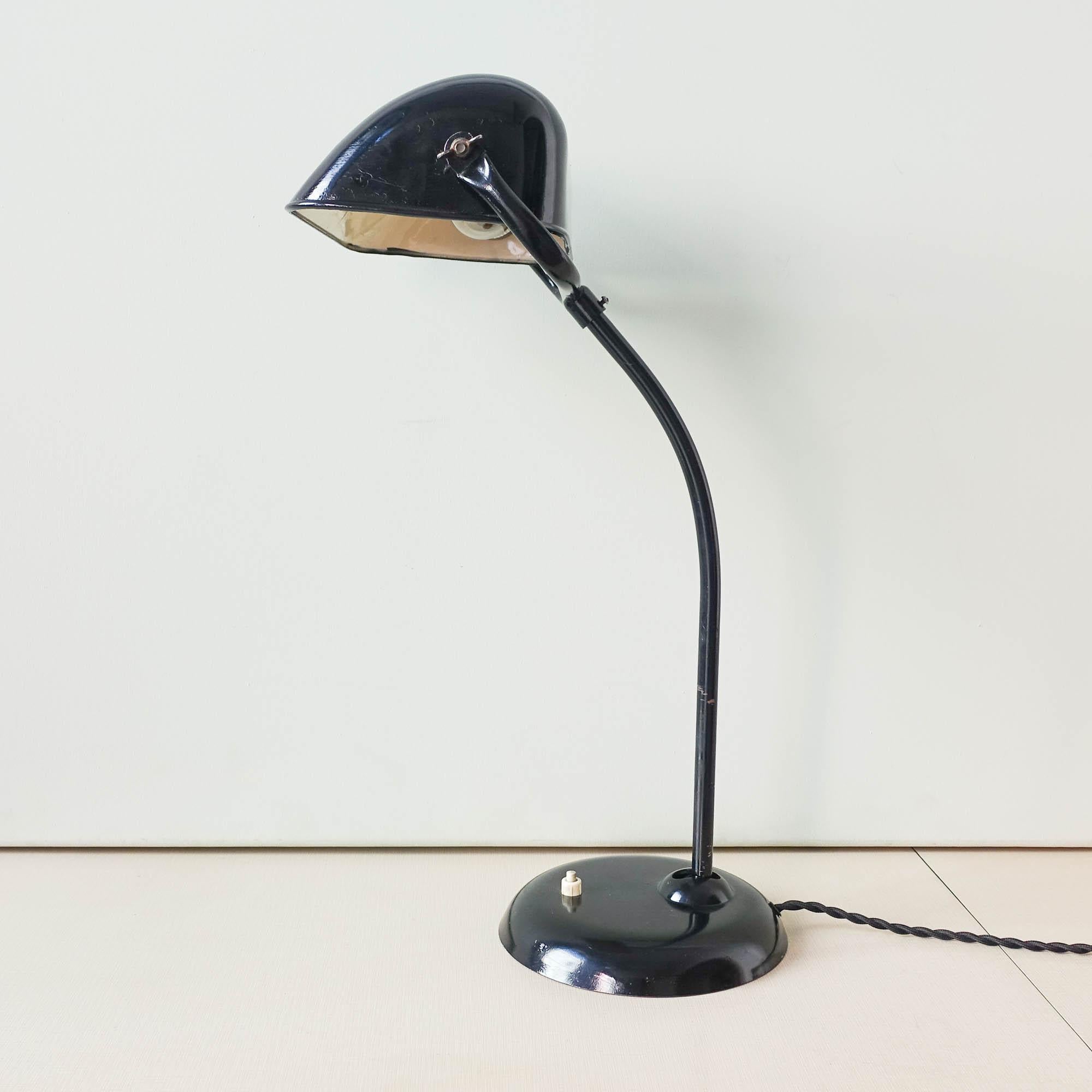 This is a very rare Bauhaus bankers lamp from Kaiser Idell, model 6581, designed by Christian Dell during the 1930's. It can be bent forward or backwards and the lampshade is also adjustable and can be bent upwards or downwards. It is made in metal