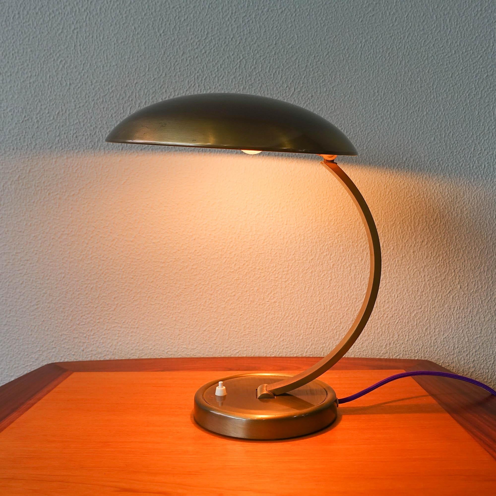 This table lamp, Model 6751, was designed by Christian Dell for Kaiser Idell, in Germany, during the 1950's. It is with original old brass polished finishing. With original label on the lampshade. In very good vintage condition.