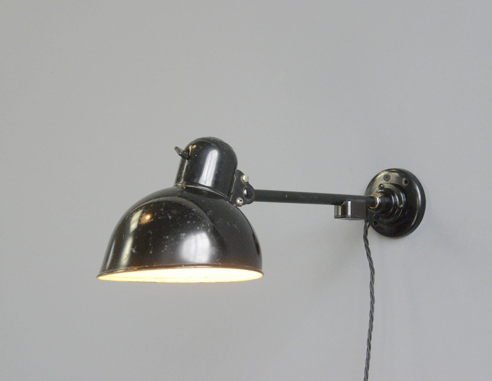 Kaiser Jdell Model 6723 wall lamp by Christian Dell

- Adjustable shade and arm
- Takes E27 fitting bulbs
- Original black paint
- Marked 