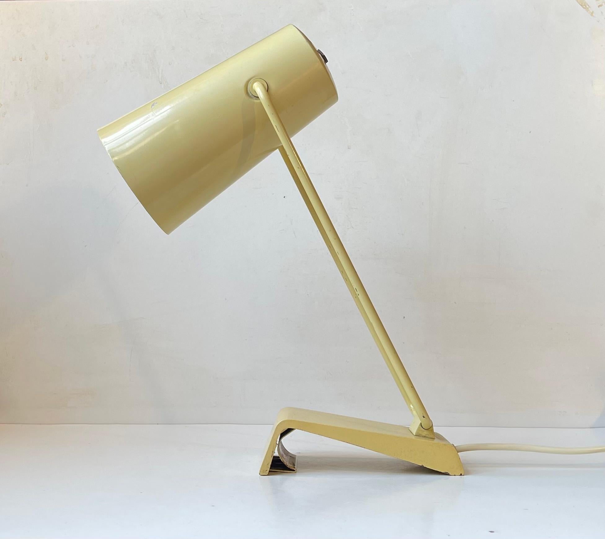 A very rare 1950s desk or wall lamp by German Kaiser Leutchten. This model 6307/111 is adjustable at the aluminum shade and at its steel base and it was only made in black, grey and pastel yellow. The retains its original socket and it still has the