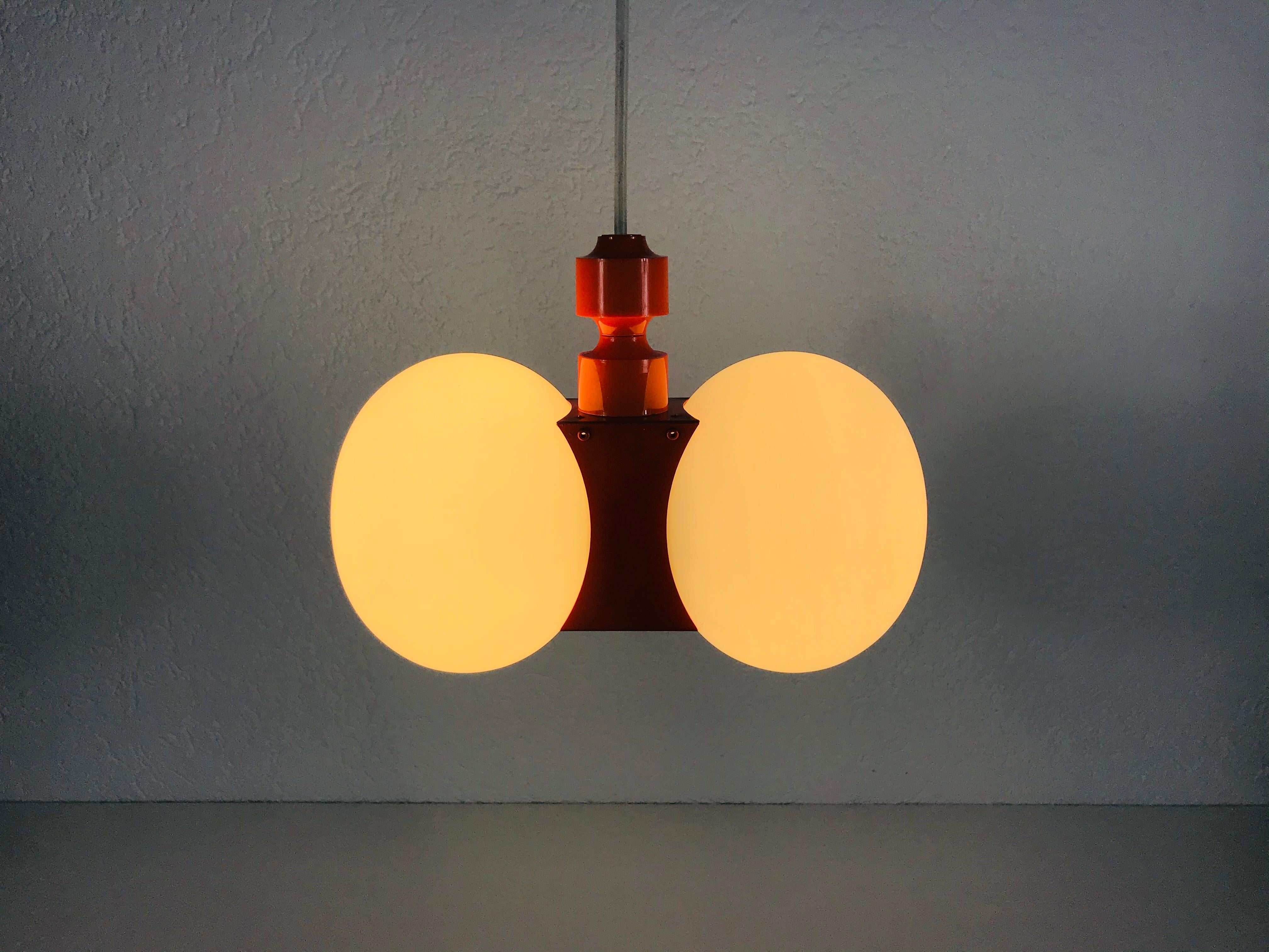 A midcentury chandelier by Kaiser made in Germany in the 1960s. It is fascinating with its Space Age design and two opaque balls. The body of the light is made of full metal, including the arms.


The light requires two E14 light bulbs.