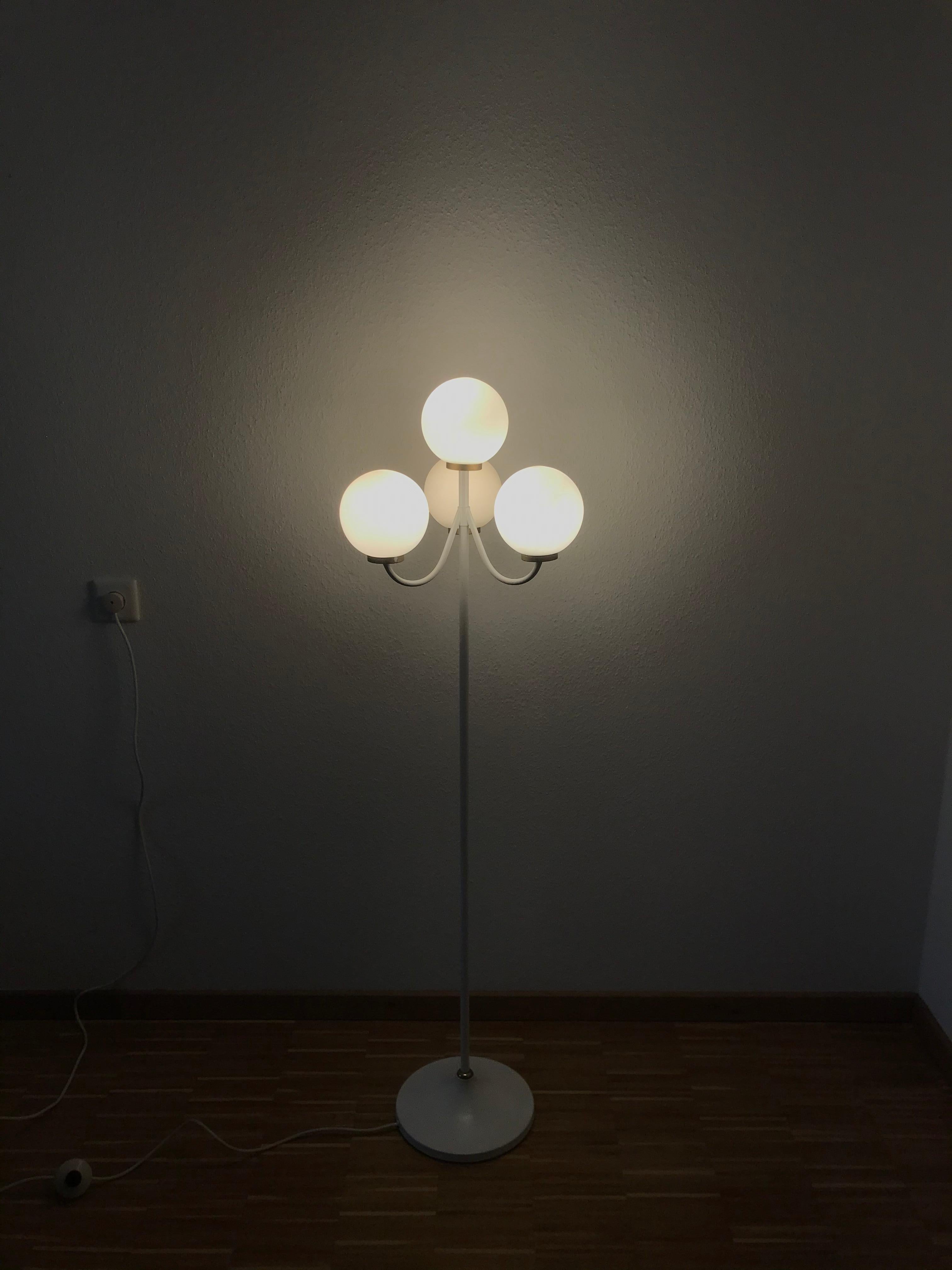 A midcentury floor lamp by Kaiser made in Germany in the 1960s. It is fascinating with its Space Age design and four opaque balls. The bottom of the light is made of full metal. The bar is also made of metal including the arms.


The light