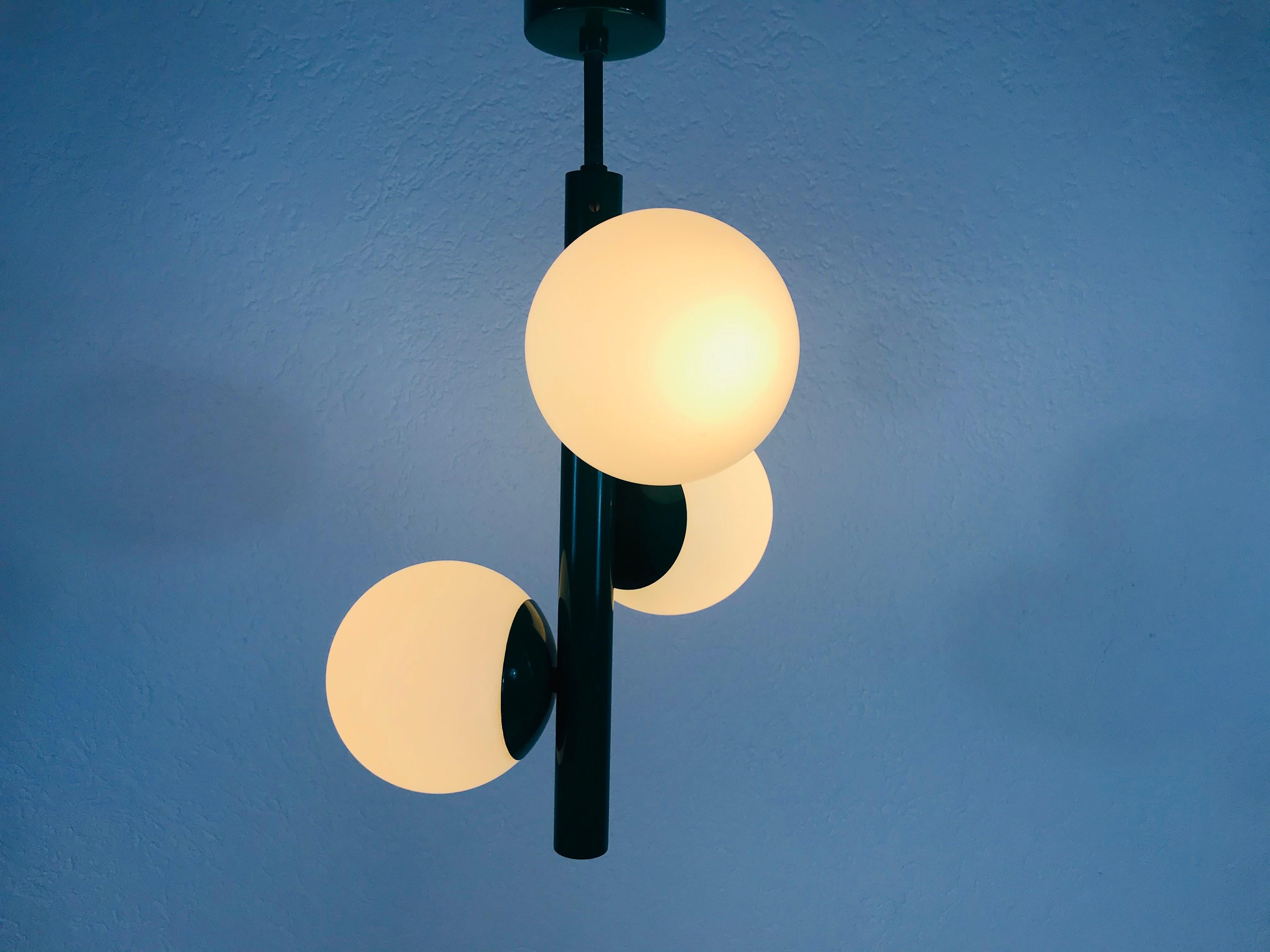 A midcentury chandelier by Kaiser made in Germany in the 1960s. It is fascinating with its Space Age design and three opaque balls. The body of the light is made of full metal, including the arms.


The light requires three E14 light bulbs.