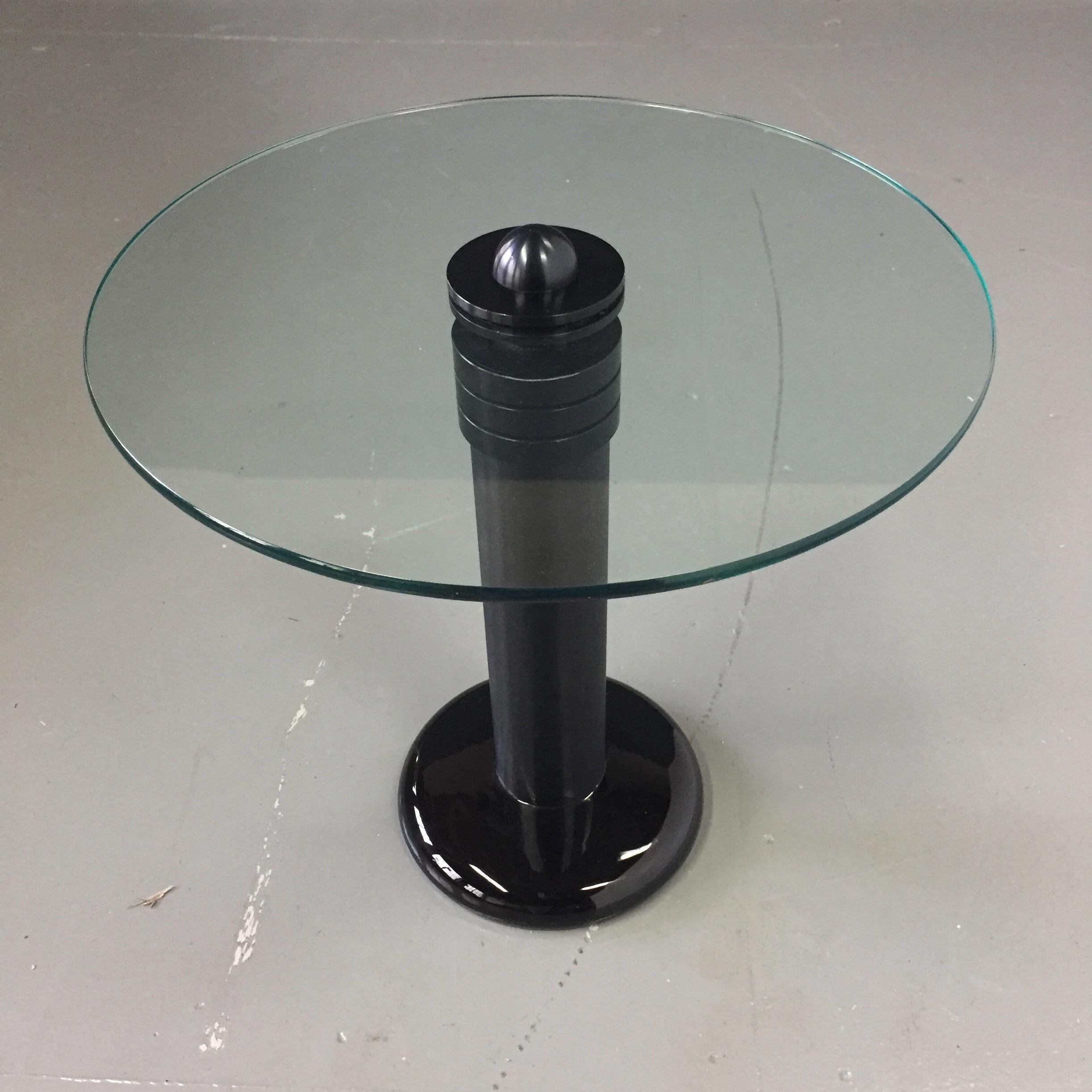 This extremely well made and highly designed Postmodern table is made of brushed aluminium, glass and has a ceramic base.

This table is produced by the well regarded Kaiser-Newman Company of Philadelphia