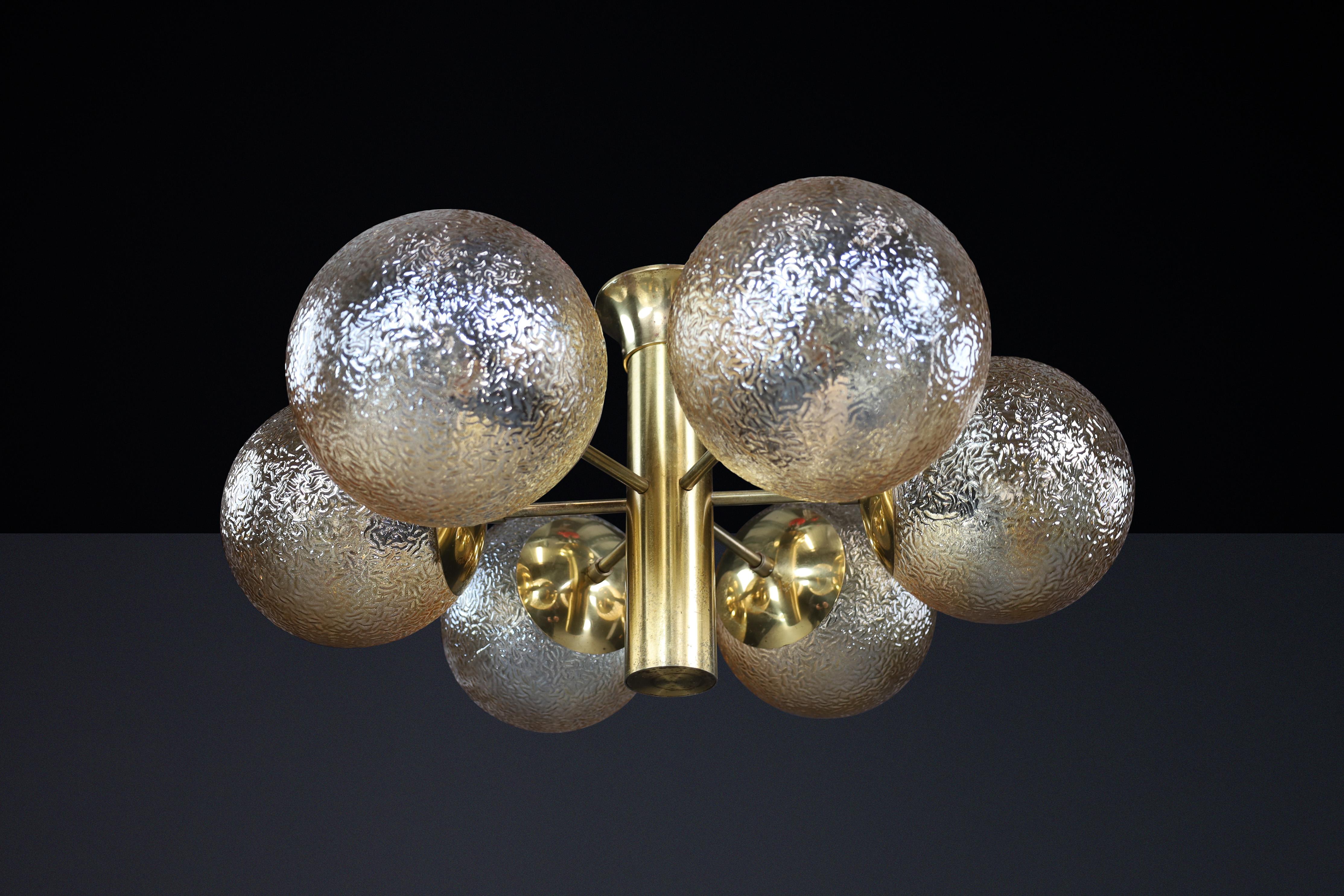 Patinated Brass Sputnik Chandelier with Six Gold-Colored Globes, Germany 1960s

This mid-century Sputnik chandelier represents a remarkable example of design excellence, crafted by Kaiser Leuchten in Germany during the 1960s. It features nine
