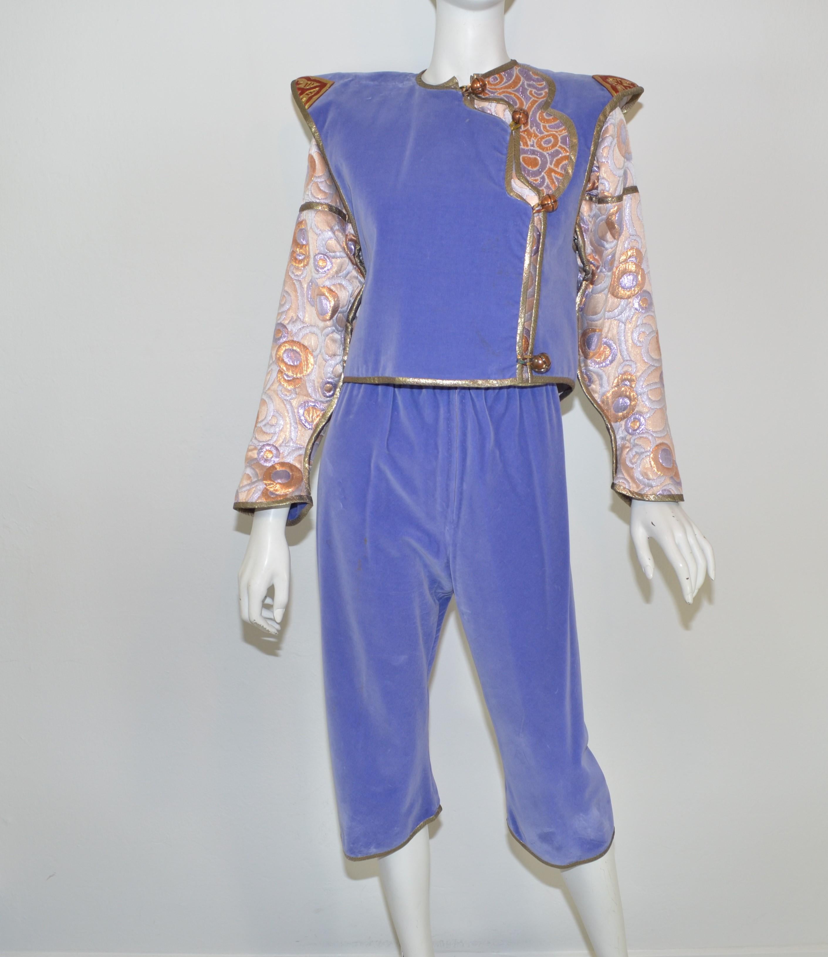 This ensemble includes: pants, jacket, chiffon blouse and vest. Pants are featured in a lavender velvet and have a lame quilted panel around the waist with a front zipper and hook fastening. Vest is reversible and has knotted button closures along