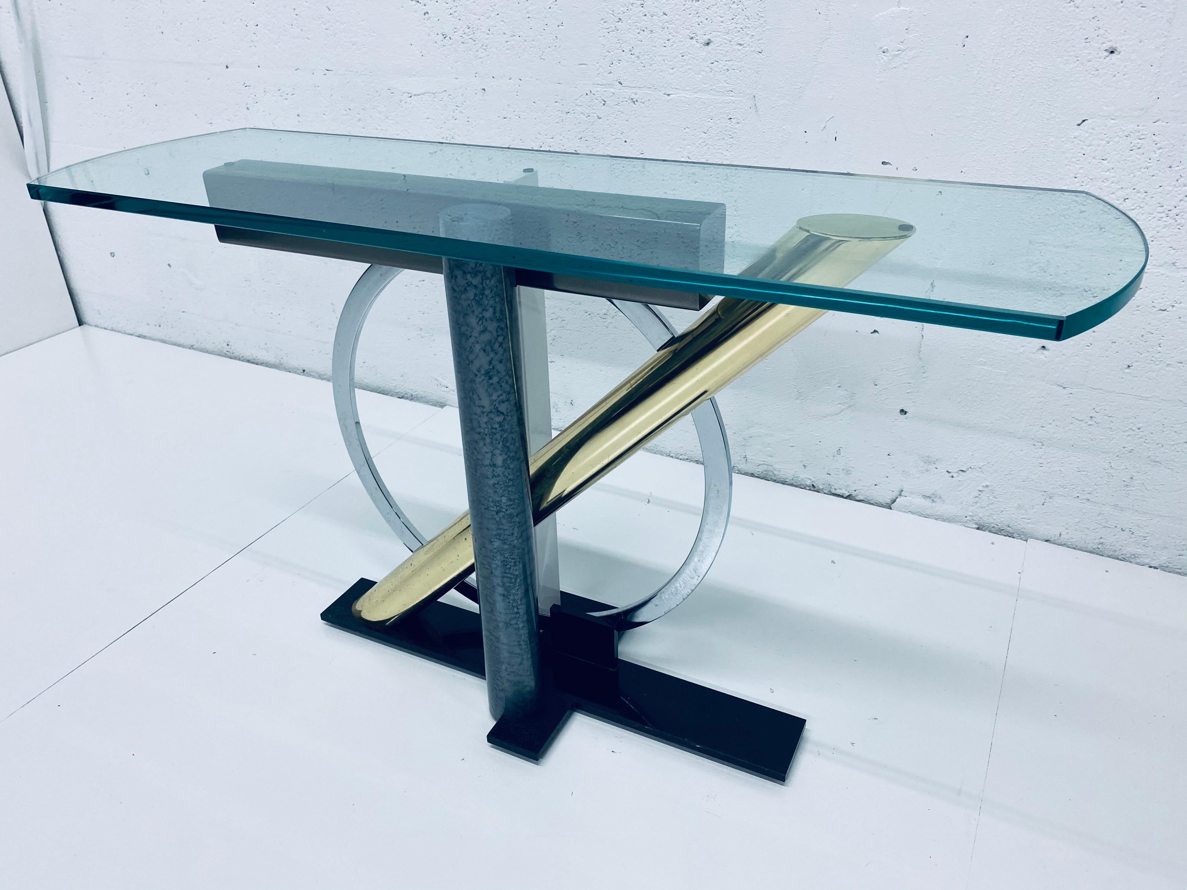 Steel, brass, chrome and glass console table in the Memphis style by Kaizo Oto for Design Institute of America. Glass is 3/4”.