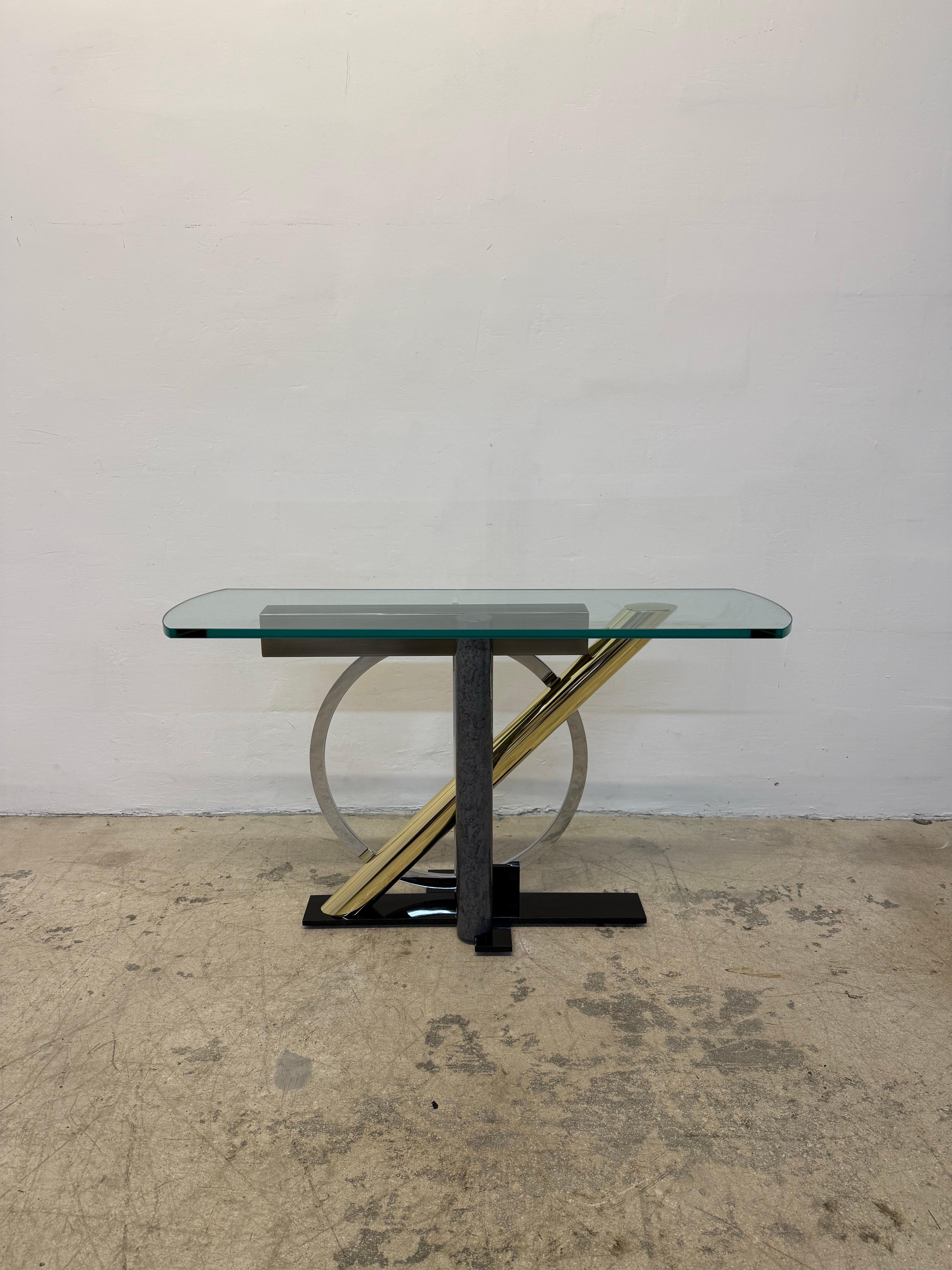 Steel, brass, chrome and glass console table in the Memphis style by Kaizo Oto for Design Institute of America. Glass is 3/4”.