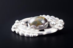 Kaj Bojesen, Randers. Oval silver brooch set with a cabochon-cut cat’s eye.