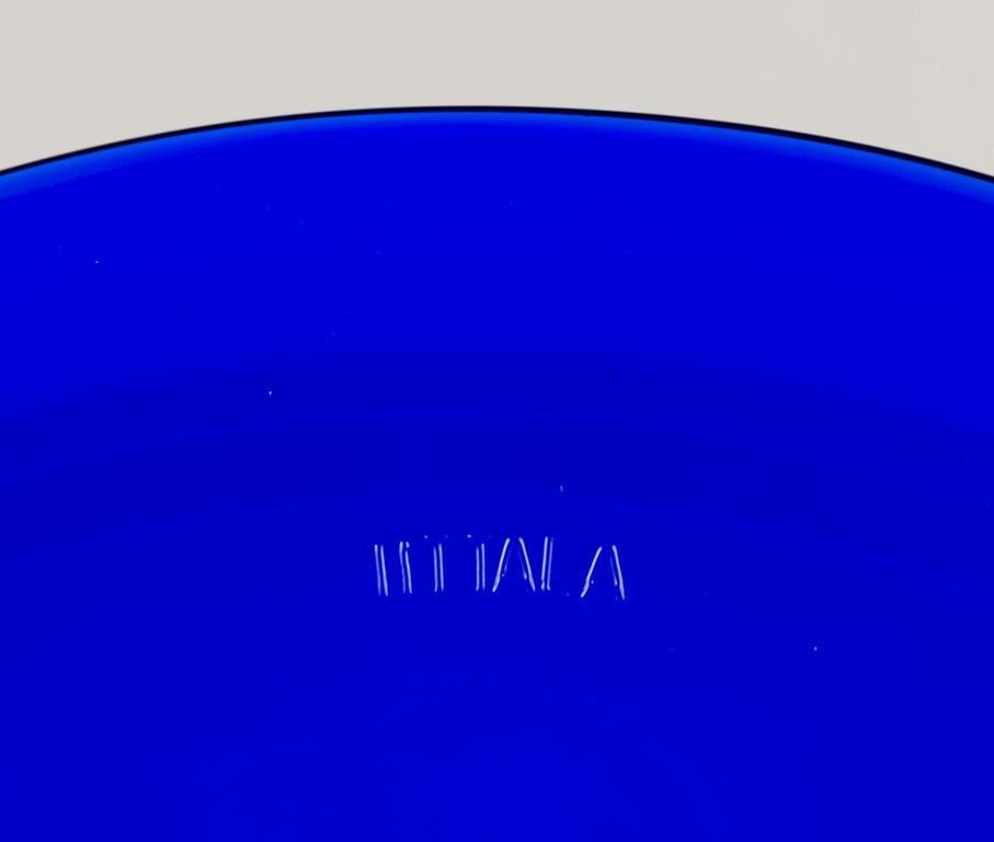 20th Century Kaj Franck for Iittala, Finland. Set of eight ‘Kartio’ plates in blue art glass.
