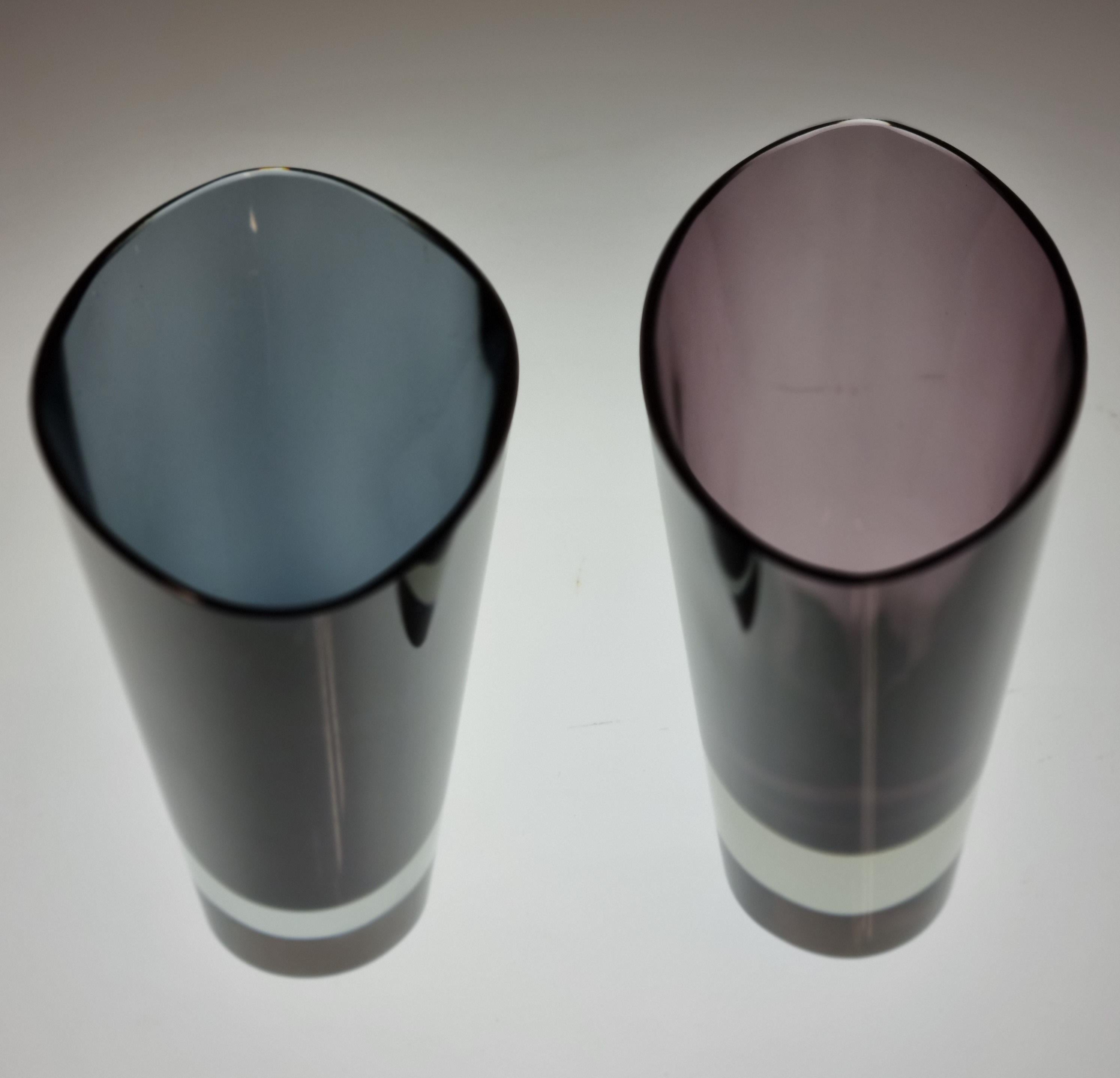 Kaj Frank (1911-1989), was a pioneer of sustainable development in the art glass area. He designed this tapered glass vase with oval rim and oval base model KF 234 and it was in producion during 1955-1964. The colors of these two vases are clear