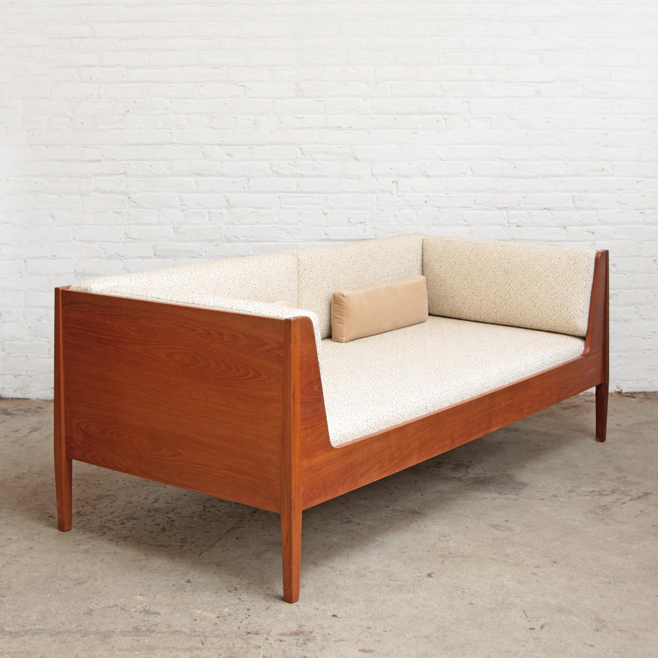 Kaj Winding daybed sofa. Newly upholstered in pebble speckly boucle upholstery and foam. Teak frame made in Denmark by Kaj Winding for Poul Hundervad (Model PH 22 BJ). Doubles single bed.