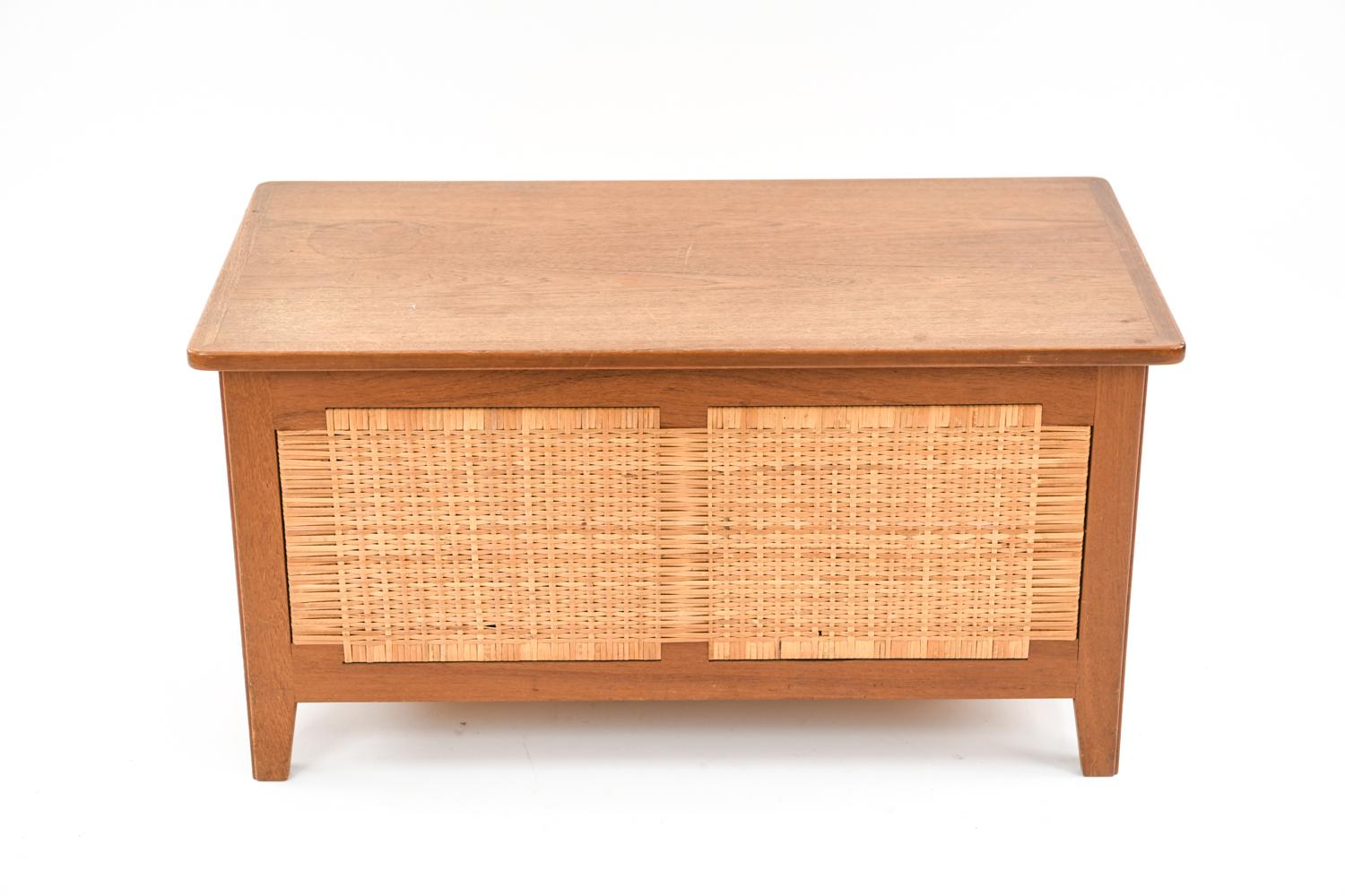 A beautiful Danish midcentury blanket chest in teak and cane, designed by Kaj Winding for Poul Hundevad, circa 1960s. This piece is model PH52 and features a sturdy teak frame with woven cane sides. A great storage piece which could easily be