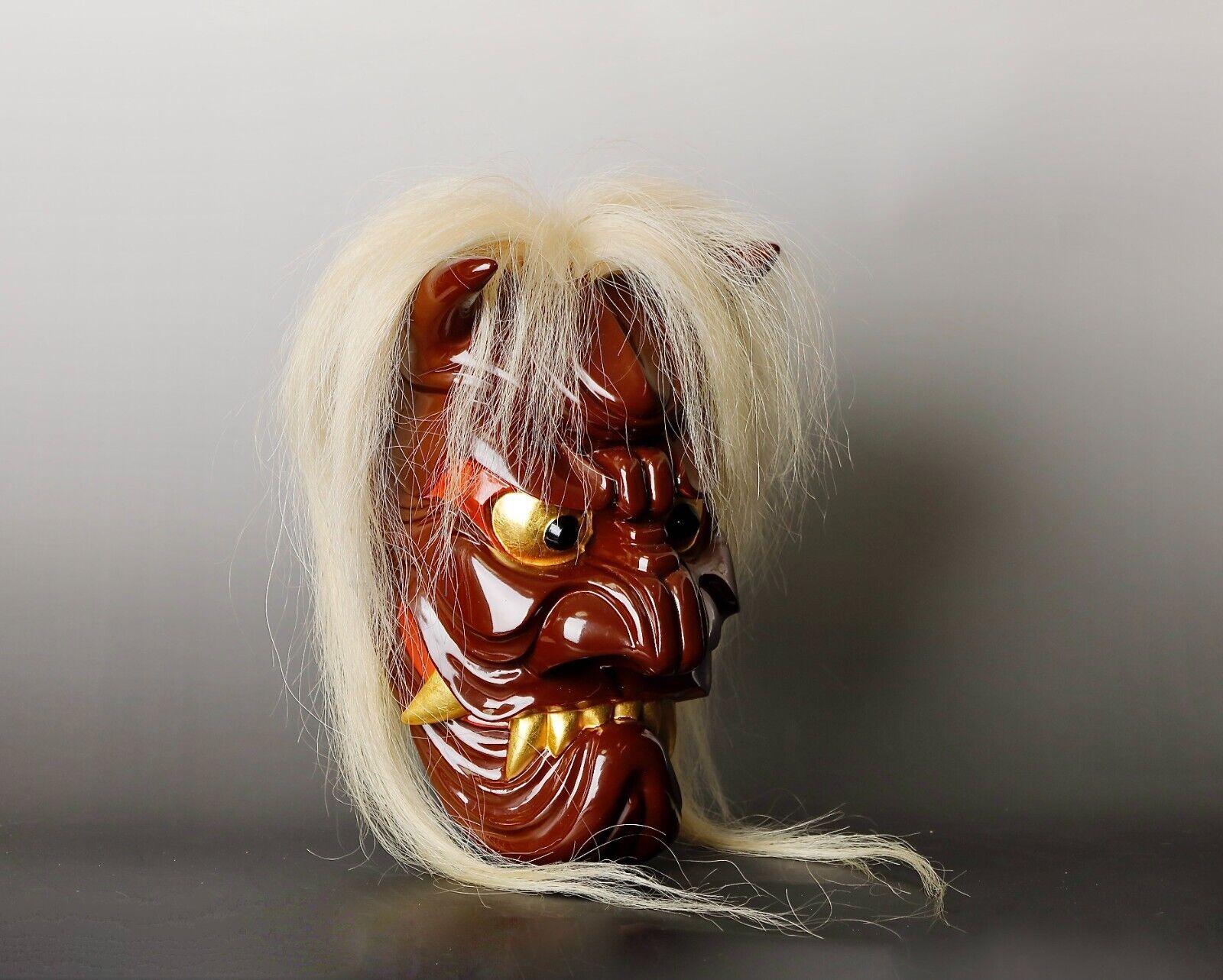 Presenting a captivating Menburyu mask, originating from Saga Prefecture's traditional temple drama theater in Japan. This particular mask represents the character of Furyu, a male evil spirit. Crafted with meticulous care, it is made from Camphor