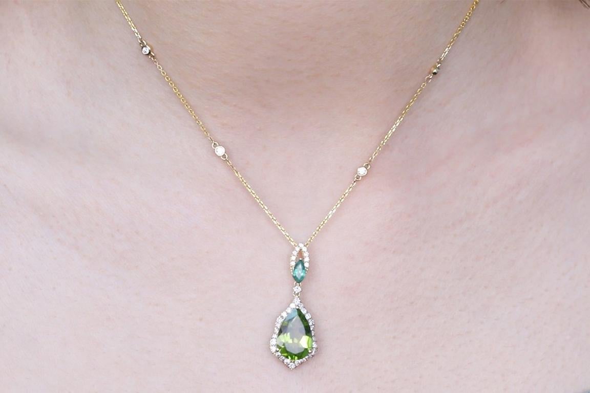 Decorate yourself in elegance with this Pendant is crafted from 14-karat Yellow Gold by Gin & Grace. This Pendant is made up of Pear-cut Peridot (1 pcs) 3.87 carat, Marquise-cut Emerald (1 pcs) 0.20 carat and round-cut White Diamond (40 Pcs) 0.56