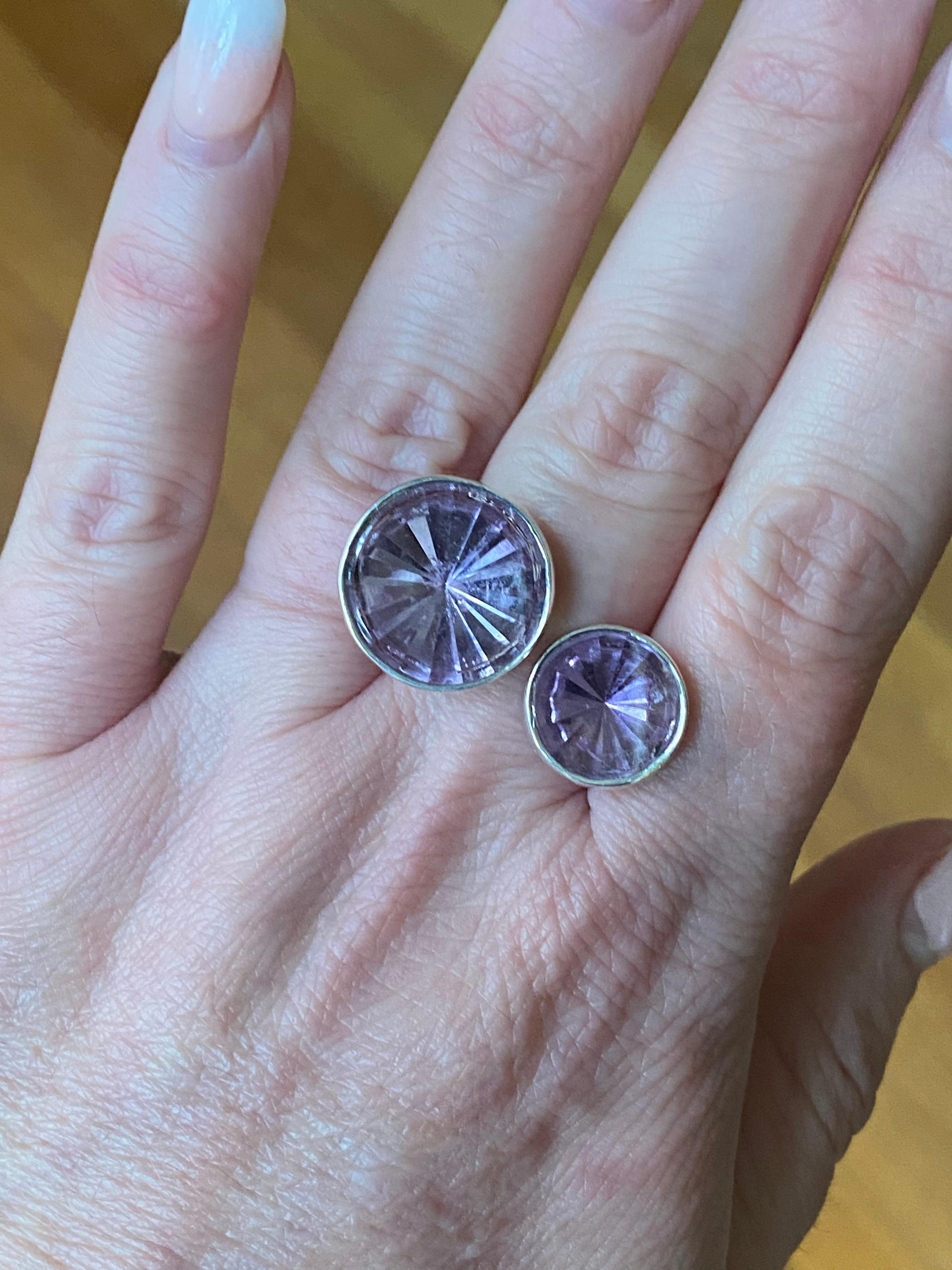 Fun Fashionable ring with 2 large Amethyst Gemstones. Faceted bottoms with a flat buffed top bezel set in Sterling Silver.
10mm = 3.30ct and 6mm = 0.70ct, weights are approximate. Finger size 6 in US measurements. In stock and ready to ship now. 
