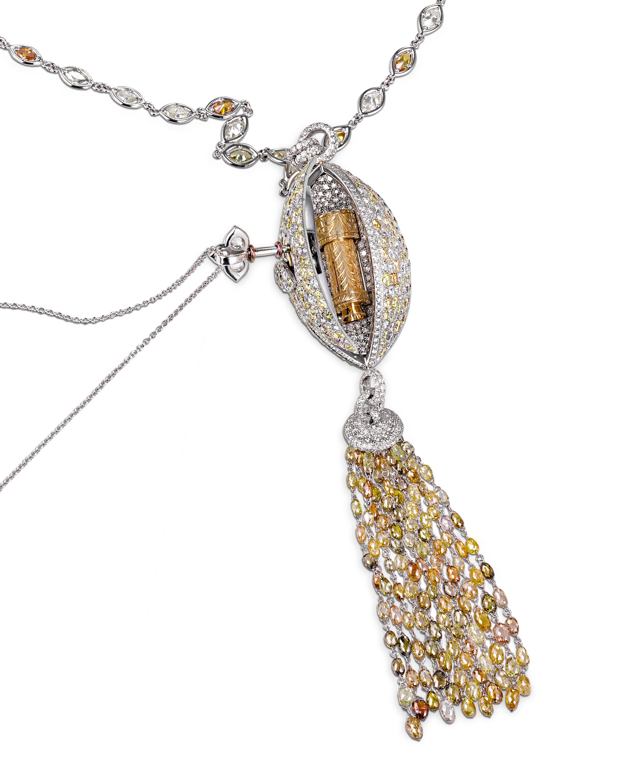 This diamond and 18K white gold pendant necklace possesses an unmatched beauty and irresistible charm. Boasting a stunning central 12.40-carat brown-yellow marquise diamond, as well as 2.80 carats of white diamonds and 8.17 carats of briolette