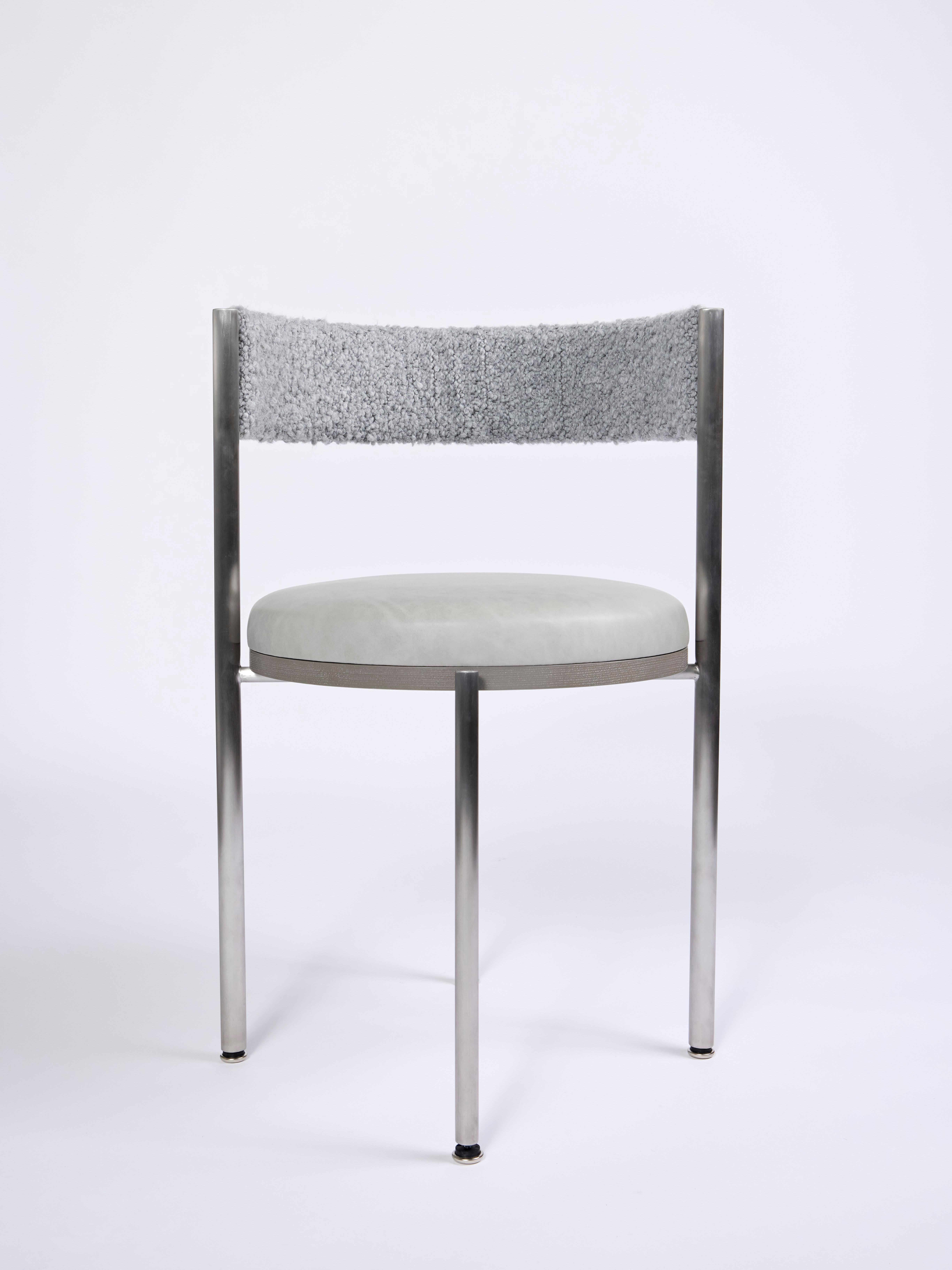 Kaleidoscope Dining Chair

Materials: stainless, leather, boucle, wood, foam 
Dimensions: 19”W x 19”D x 29”H

A monochromatic chair based on the infinite combinations of gray as color, material, and form. The limited use of color enhances the