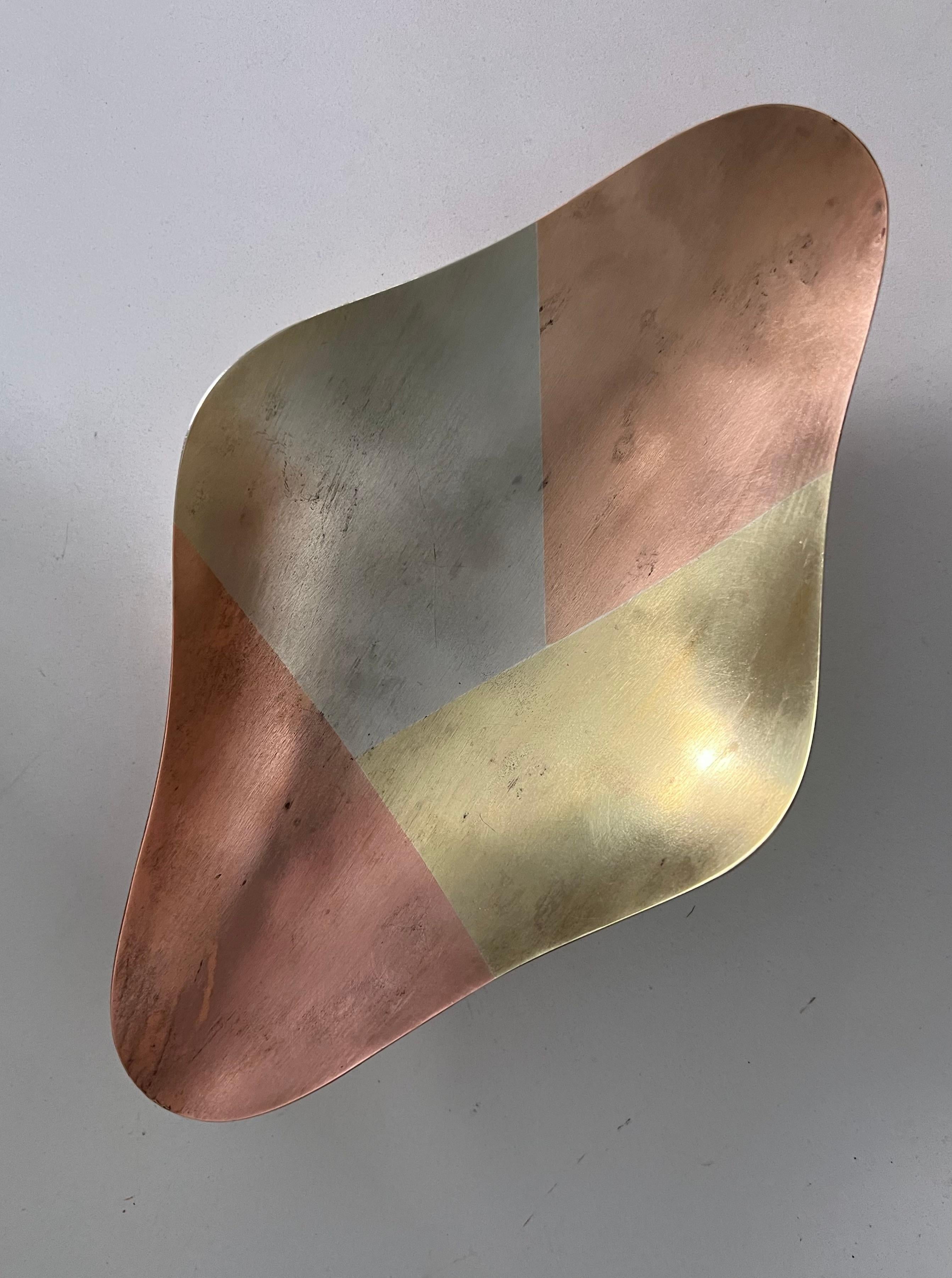 Multi-metal kaleidoscopic tray with charming patina. A gorgeous freeform shape with a slight concavity to draw its contents to center. 

Small round feet give this piece height and stability. A compliment to any entry table or vanity. Great for