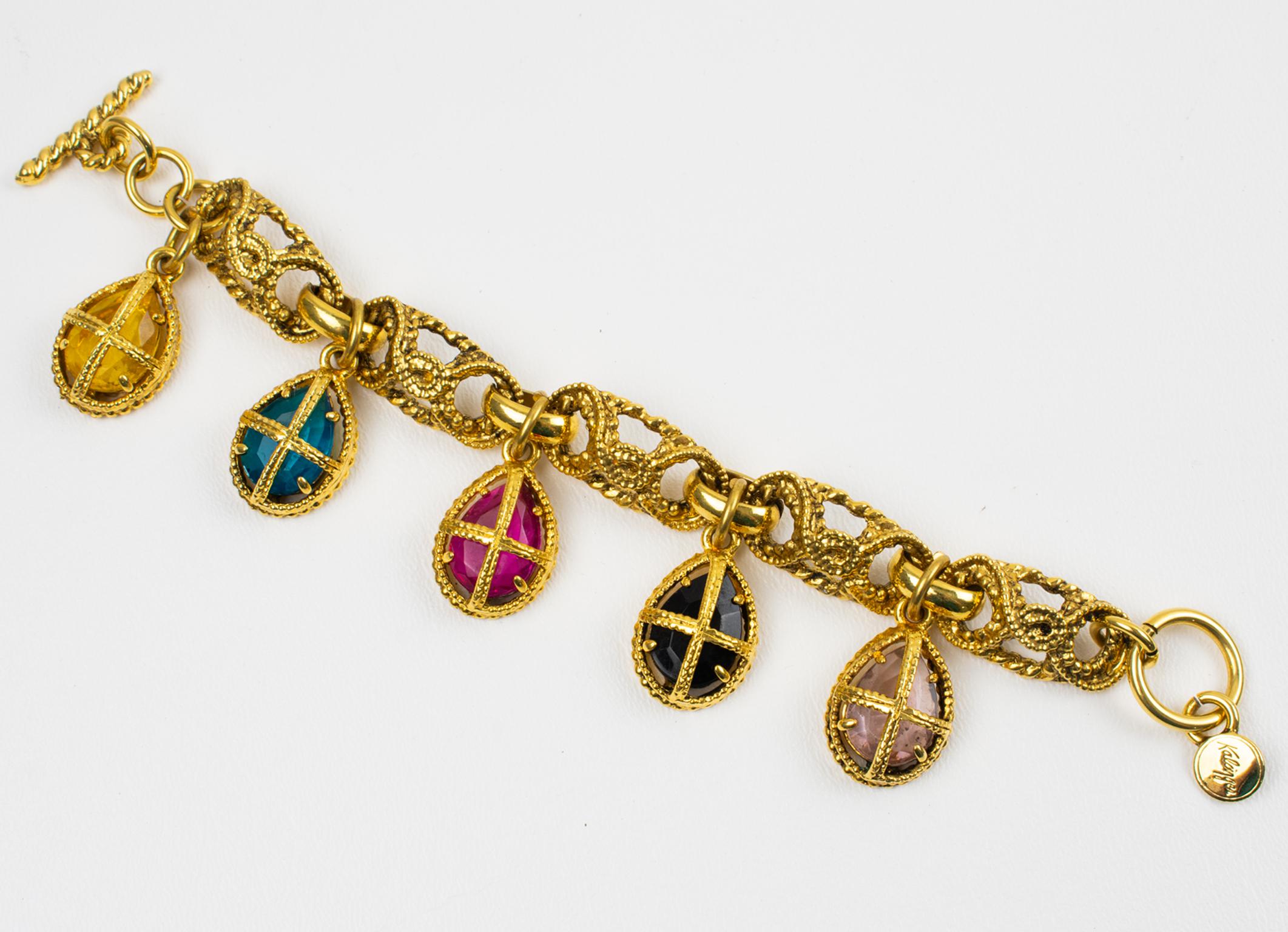 Exquisite Kalinger Paris romantic link bracelet. Chunky gilt metal all textured chain ornate with jewel dangling charms with cage trapped pear-shaped crystal rhinestones. Assorted colors of topaz yellow, emerald turquoise, fuchsia pink, licorice
