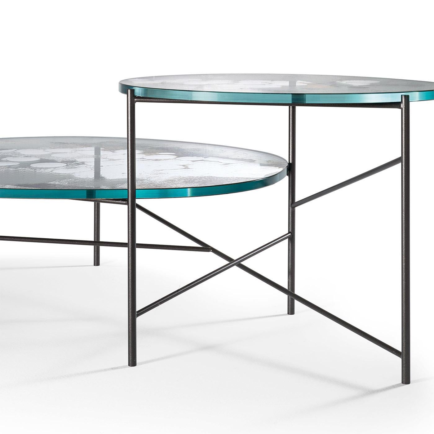 This contemporary coffee table is part of the innovative K Collection designed by Giovanni Luca Ferreri that showcases decorative mirrored surfaces in a sleek and essential frame. These structures define clear and three-dimensional geometries, in