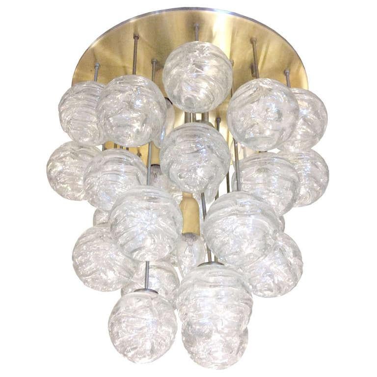 A round brass ceiling fixture with multiple hanging texture glass ball by J. T. Kalmar, Austrian 1960's