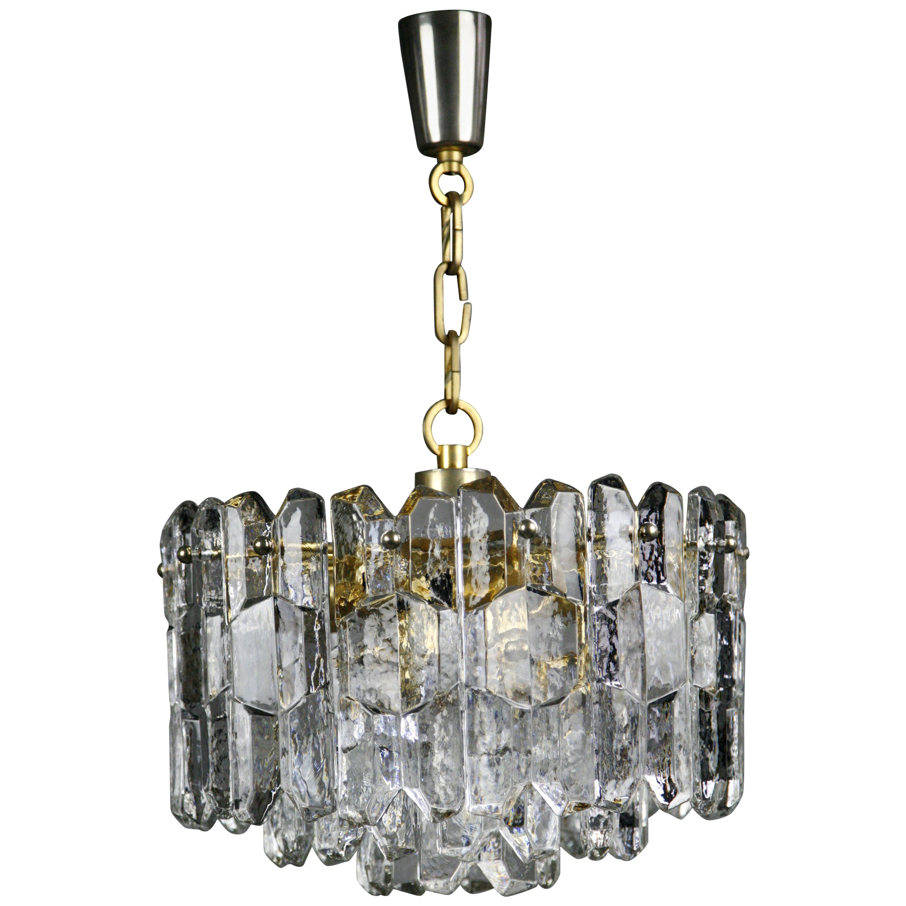 Kalmar gold crystal glass chandelier, 1970, Austria.
Patinated gold gilded frame holding numerous pieces of thick press crystal glass,  there is seven original European light sources that illuminates the glass sideways and one downward.


 