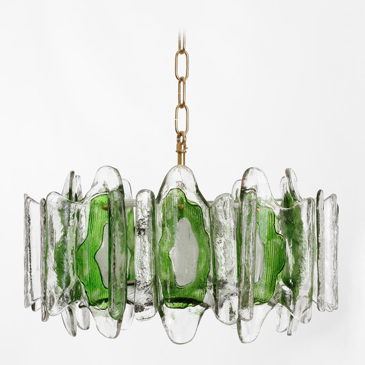 A beautiful pendant chandelier made of melted green and clear Murano glass by Kalmar, manufactured in midcentury, circa 1970 (late 1960s or early 1970s).
The light fixture has five sockets for small Edison screw base bulbs type E14 (max. 40W per