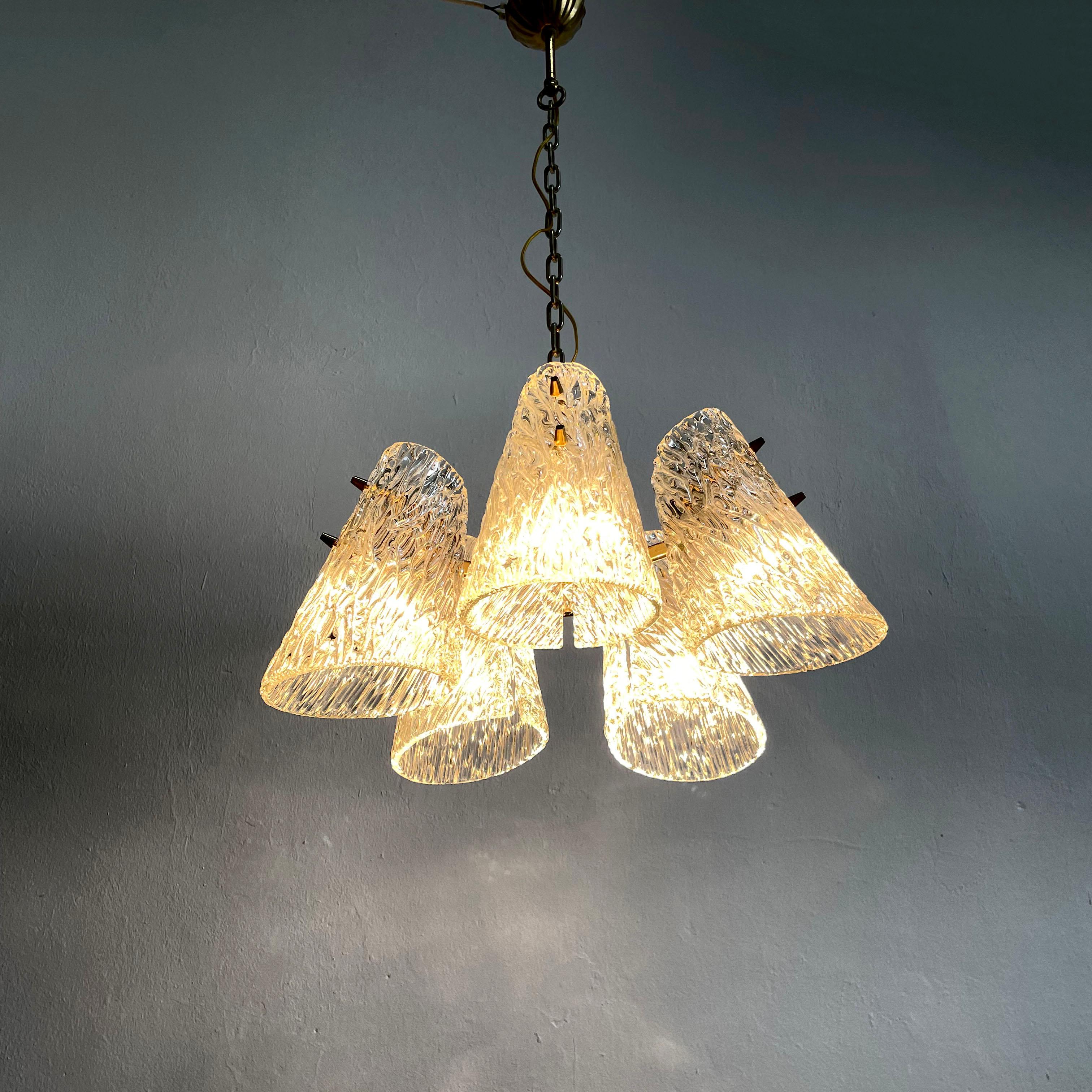 Beautiful and luxurious 1960's chandelier / pendant light by J.T. Kalmar, Austria, manufactured in midcentury, circa 1960 (late 1950s or early 1960s).

The chandelier is made of textured glass and brass

A five-arm brass frame holds cone shaped