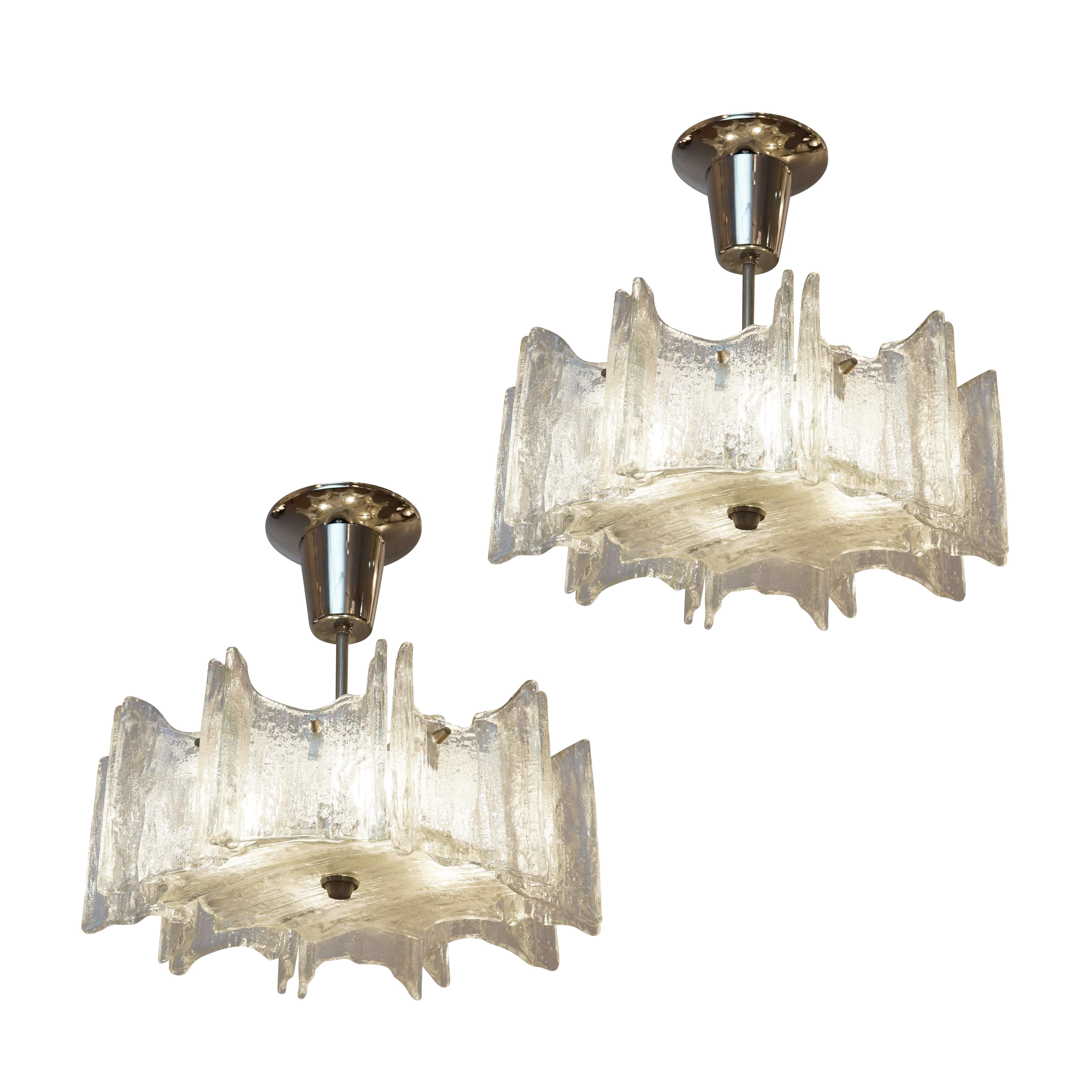 Pair of Mid-Century chandeliers by Kalmar made in the 1960’s using textured Murano glass. Polished nickel hardware holding 4 candelabra sockets. Sold individually-price per fixture.

Condition: Excellent vintage condition, minor wear consistent with