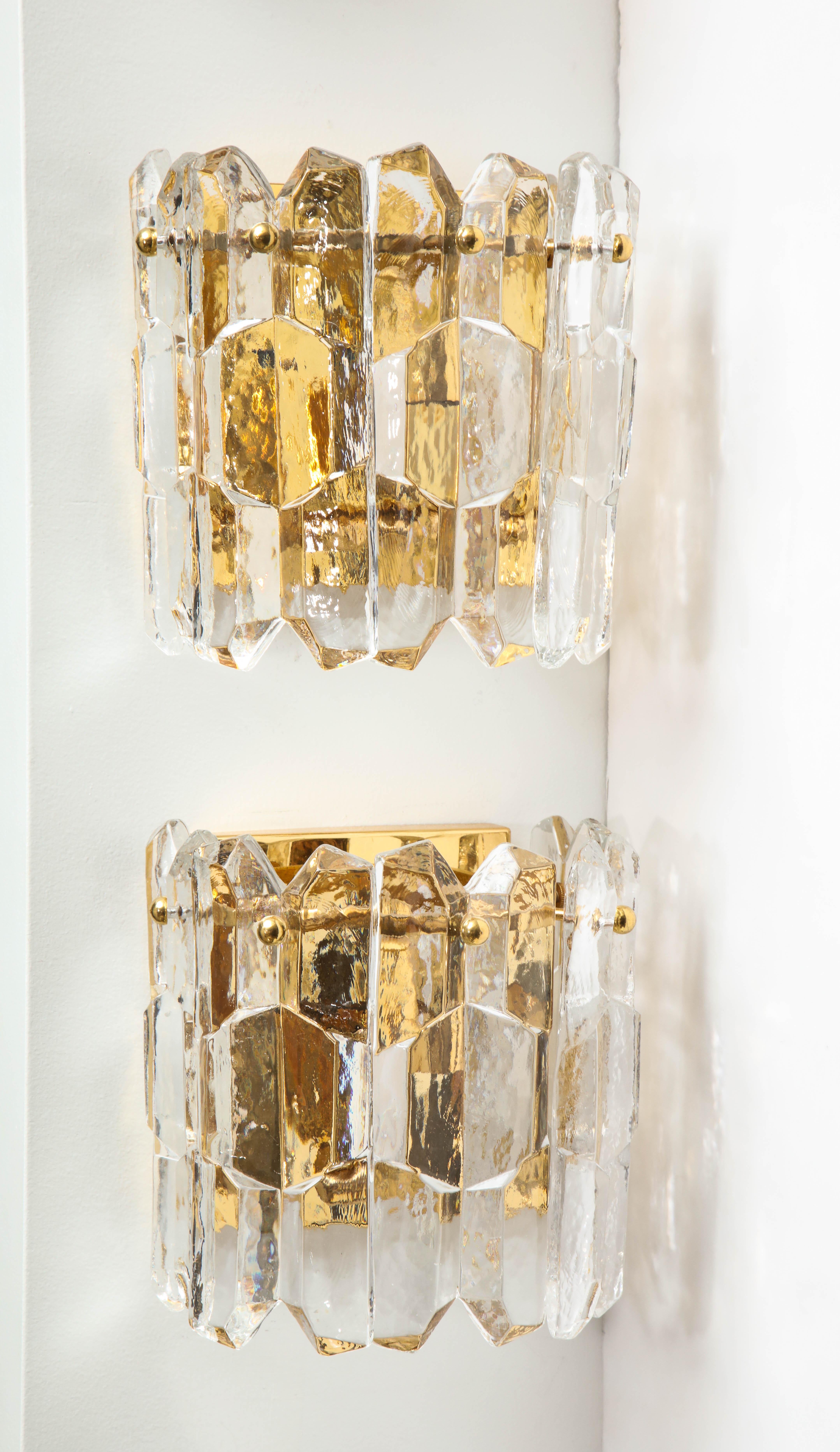 Pair of chiseled textured glass sconces on brass backplates. Each sconce features 5 glass panels and has 2 light sources. Rewired for use in the USA.