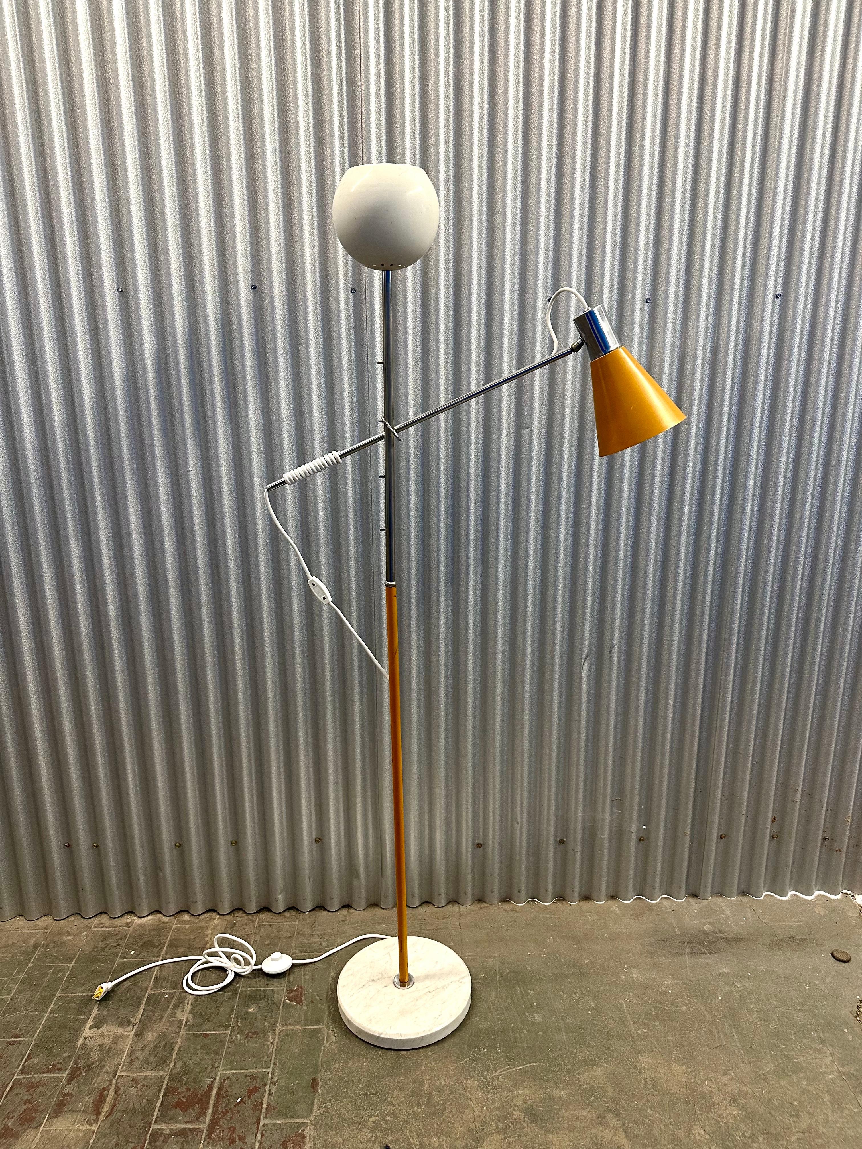 Floor lamp with white enamel torchiere shade over cantilever reading light with mustard yellow enameled shade that can be adjusted for height by simply slipping it up or down the chrome and enamel standard.  On white marble base. 