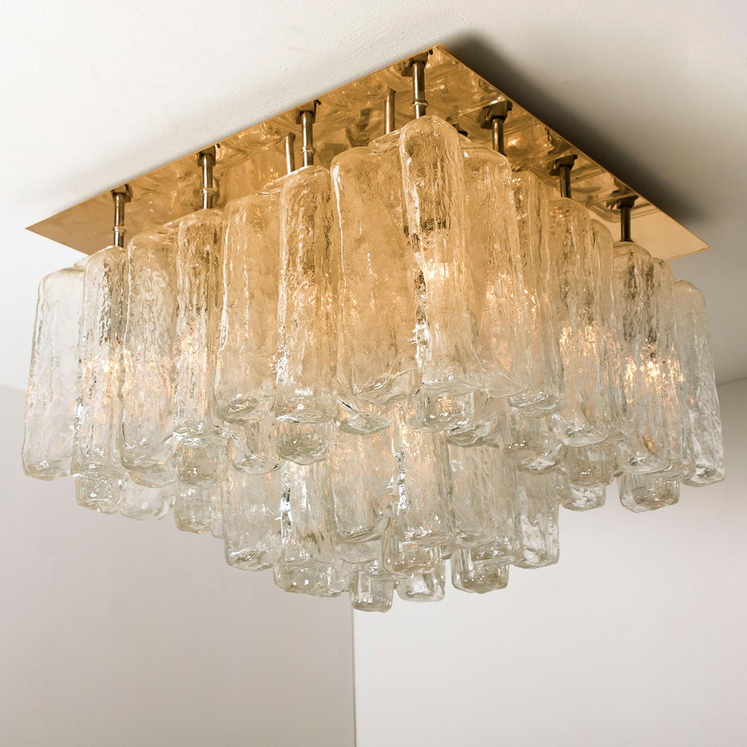 1 of the 2 stunning flush mounts by Kalmar, Austria, manufactured in 1960s.

The flush mount is composed of thick textured ice glass elements (Granadas) attached to a gold-brass frame. The glasses are made of so called foam glass, there are many