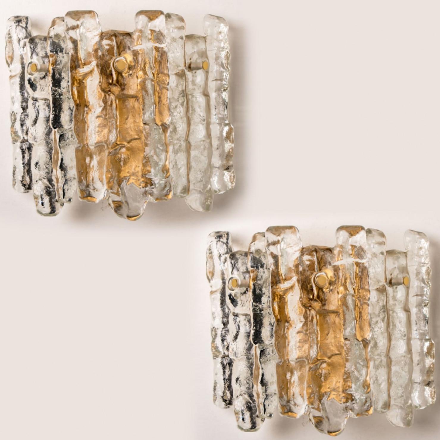 Beautiful and elegant modern ice glass and brass wall lights / sconces, manufactured by J.T. Kalmar, Austria in the 1970s.
Lovely design, executed to a very high standard. Each wall light has three solid ice glass sheets dangling on it. Clean lines