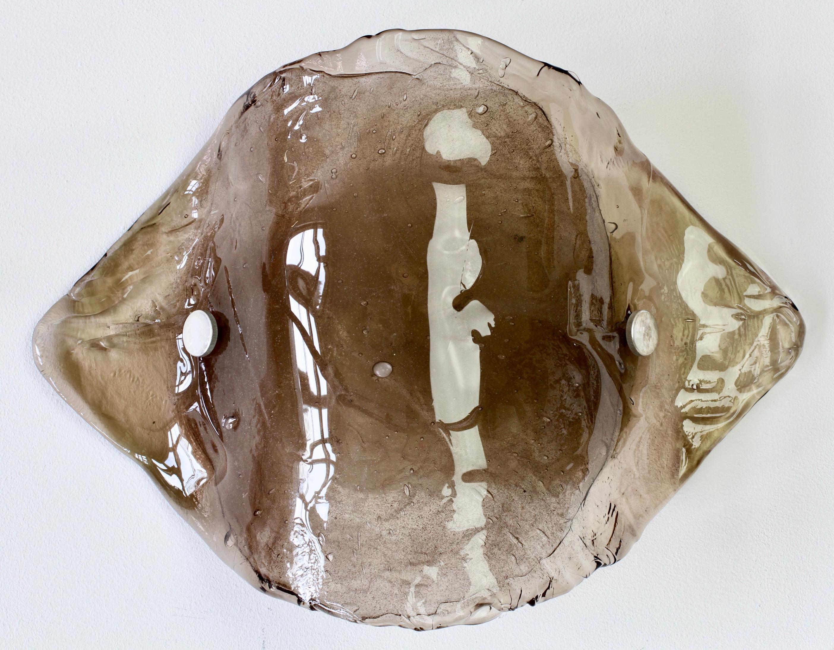 Kalmar large & elegant vintage Mid-Century Modern Austrian made Murano glass wall light., lamp or sconce, made circa 1970. The light / sconce features a large handmade piece of clear glass with a brown toned centre held, by two steel screws, to a