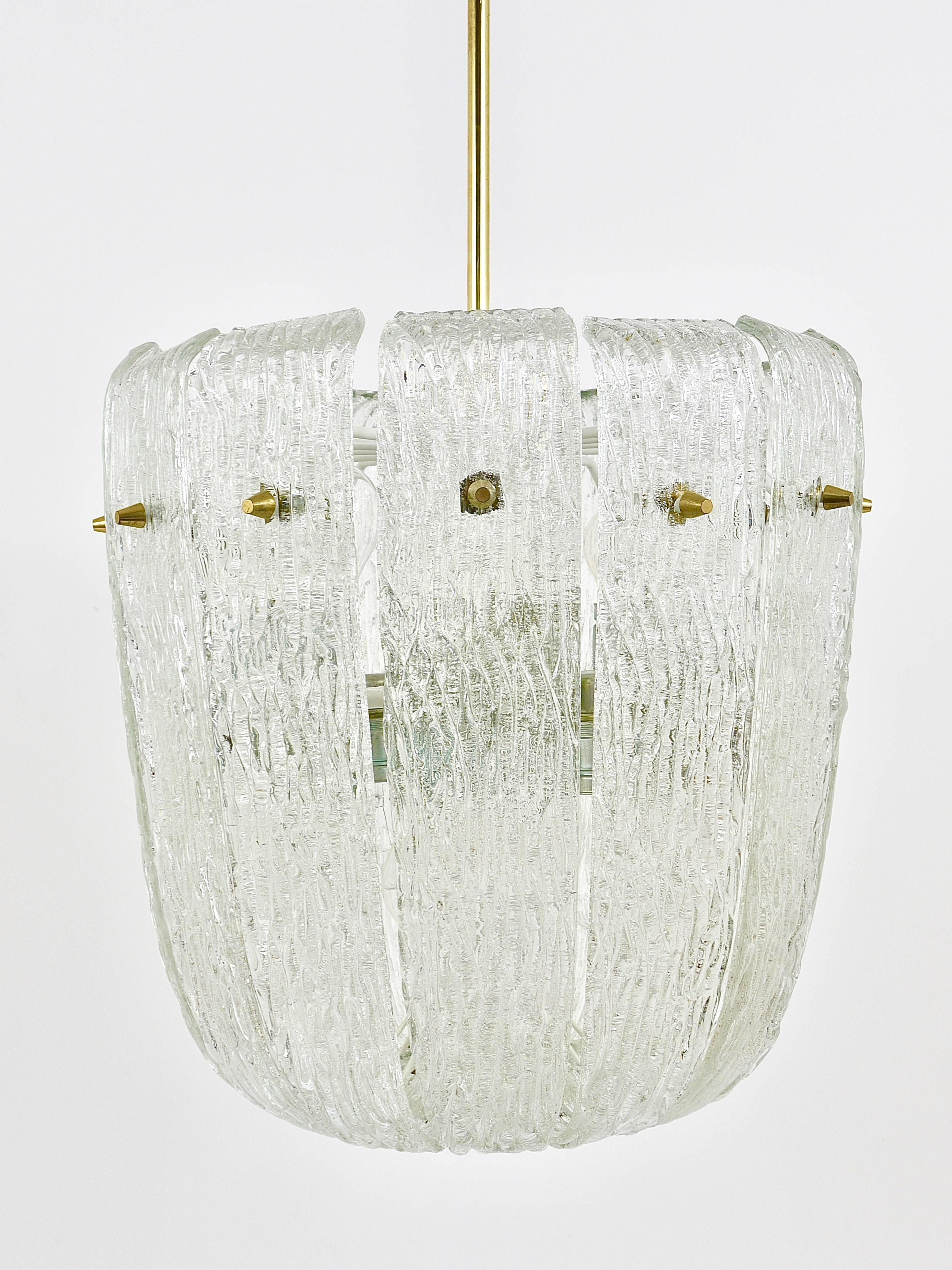 A beautiful Austrian modernist brass chandelier by Kalmar from the 1950s. Has lovely curved textured glasses, which remind of melting ice. The chandelier has 12 sockets and is in very good condition with marginal patina on the brass. 

Measures:
