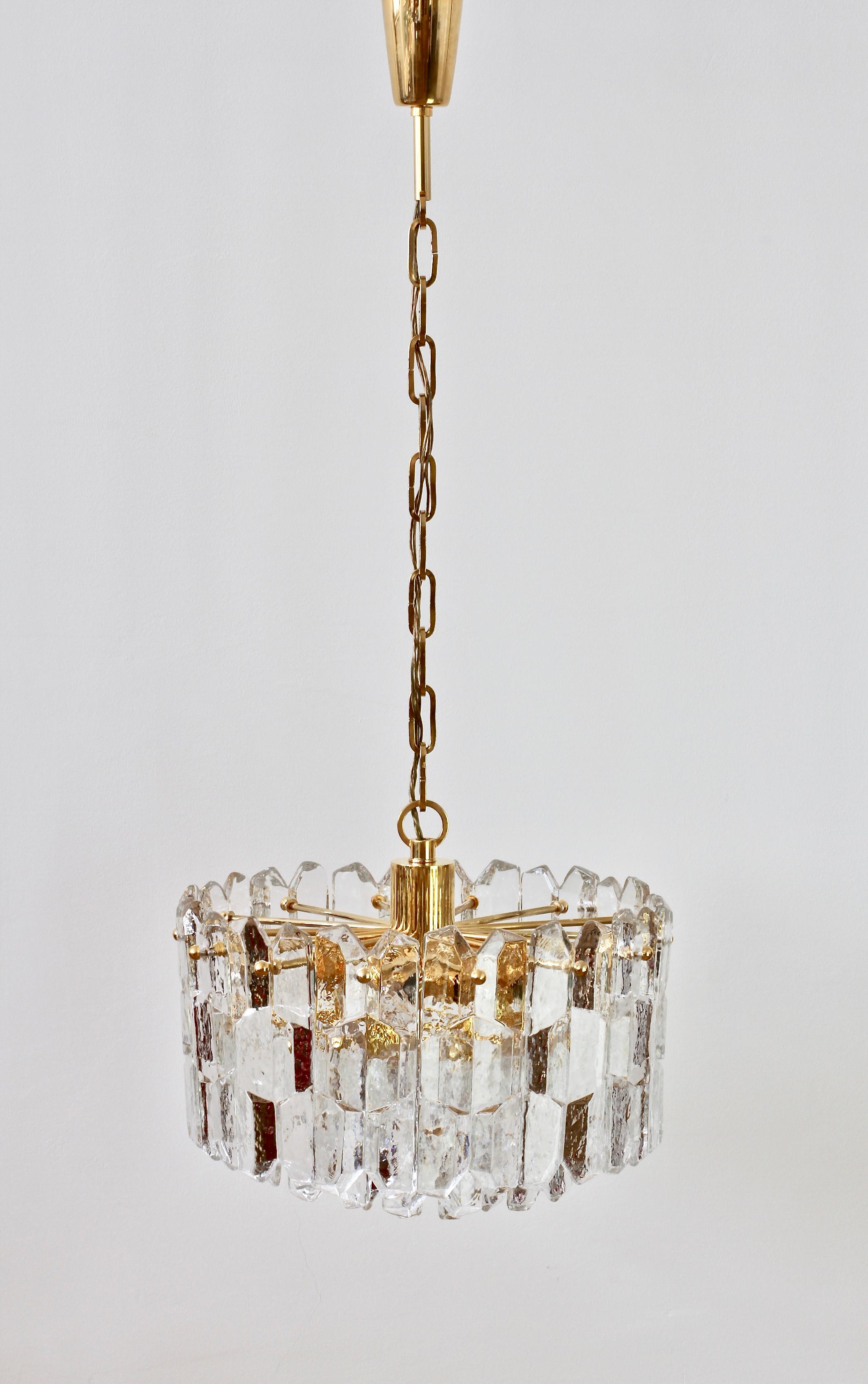 Mid-Century Modern, vintage, Austrian made 'Palazzo' ice crystal glass chandelier by Kalmar, circa 1970. Featuring twenty-six hanging glass elements resembling melting ice crystals suspended from a 24-karat gold plated brass hardware.

This