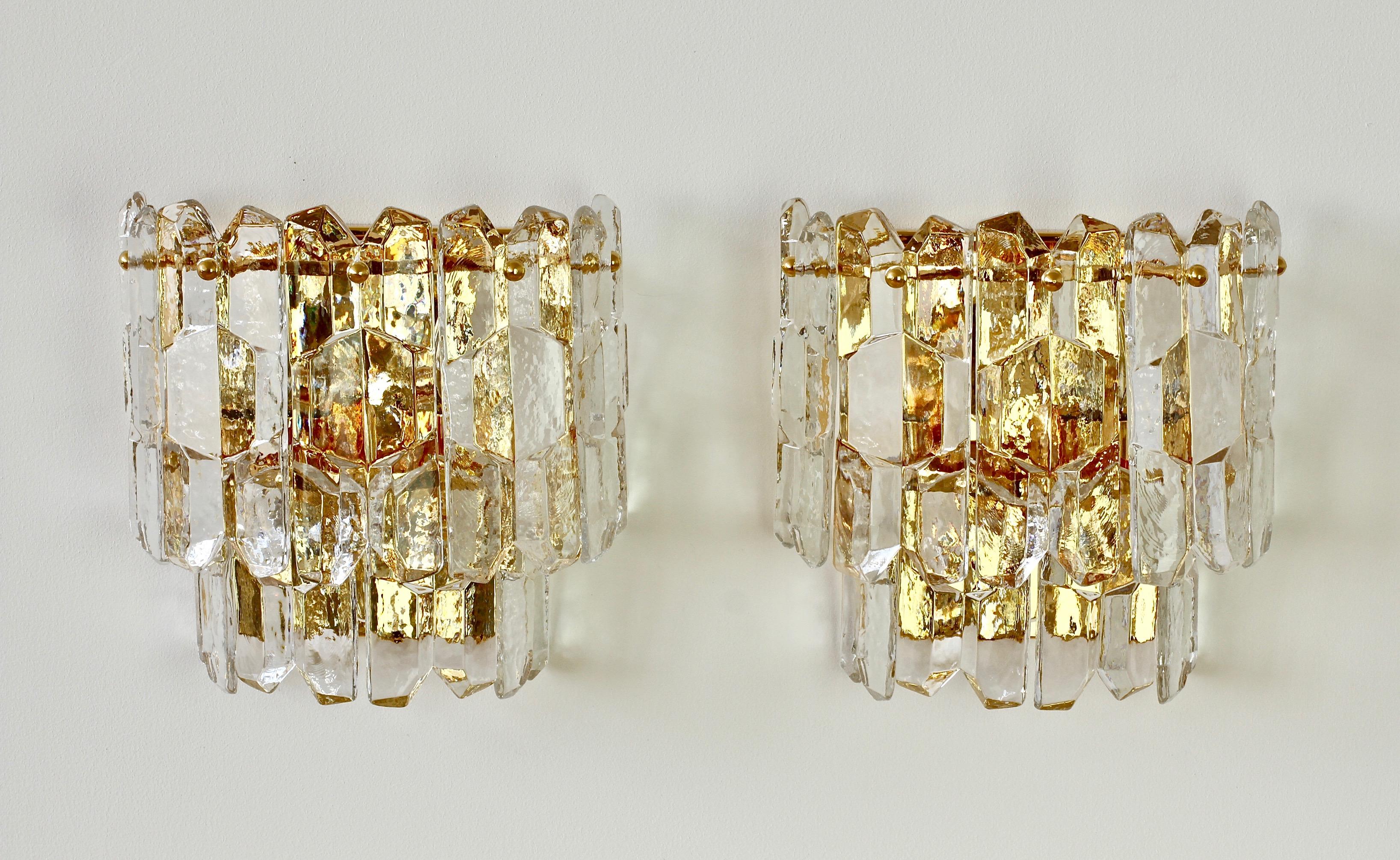 Austrian made 'Palazzo' ice crystal glass wall sconces or lights by Kalmar, circa 1960. Featuring nine hanging glass elements resembling melting ice crystals suspended from a 24-karat gold plated brass mount or bracket.

Can be used with original